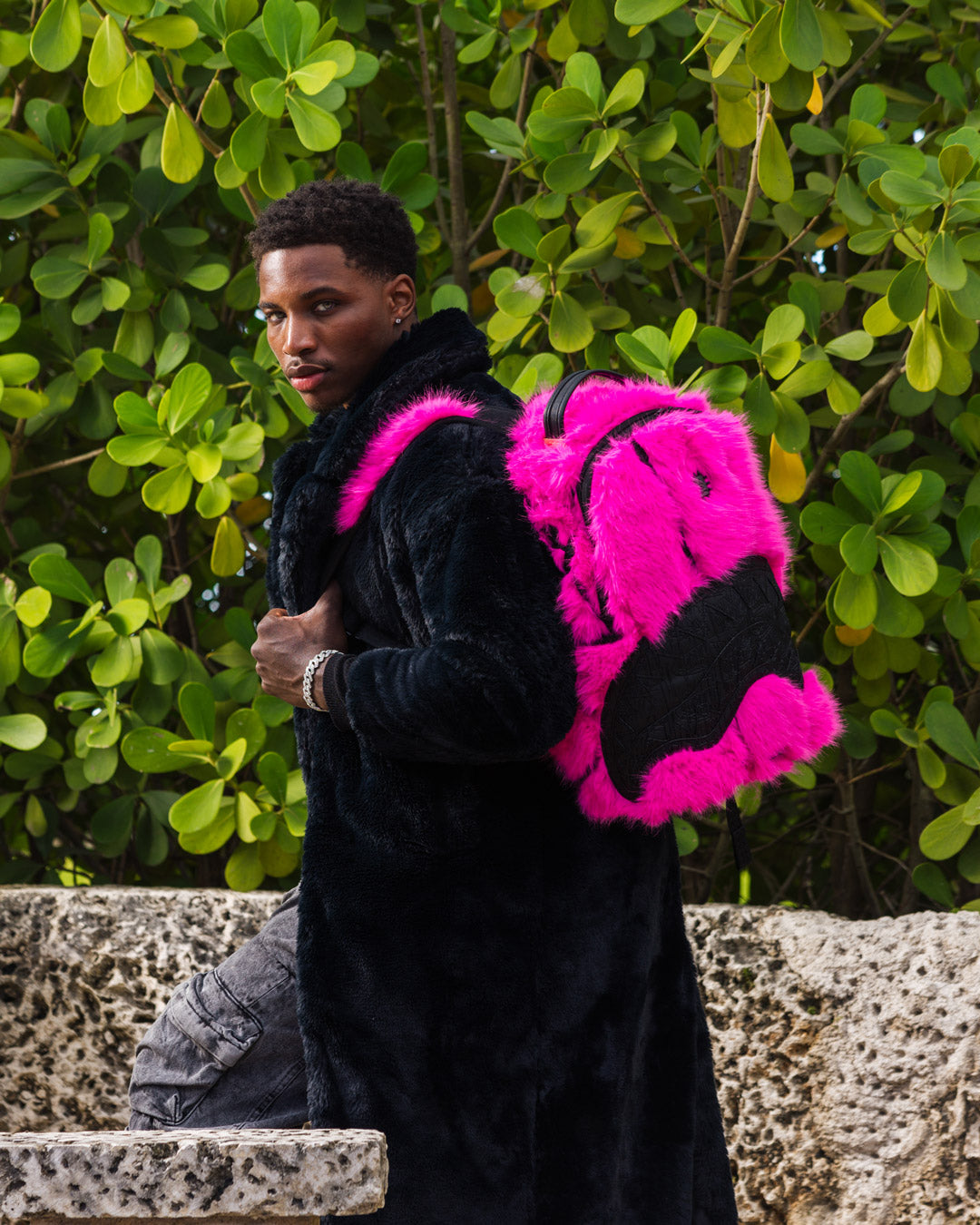 A.I. x Sprayground faux leather backpack worn by a traveler in the city