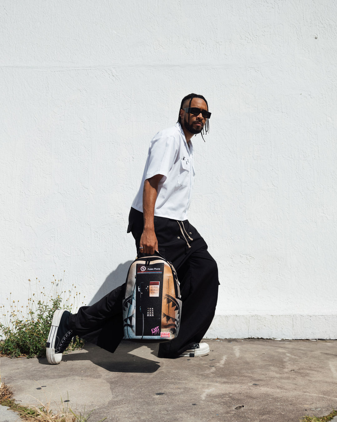 Side angle of the designer backpack highlighting adjustable straps.