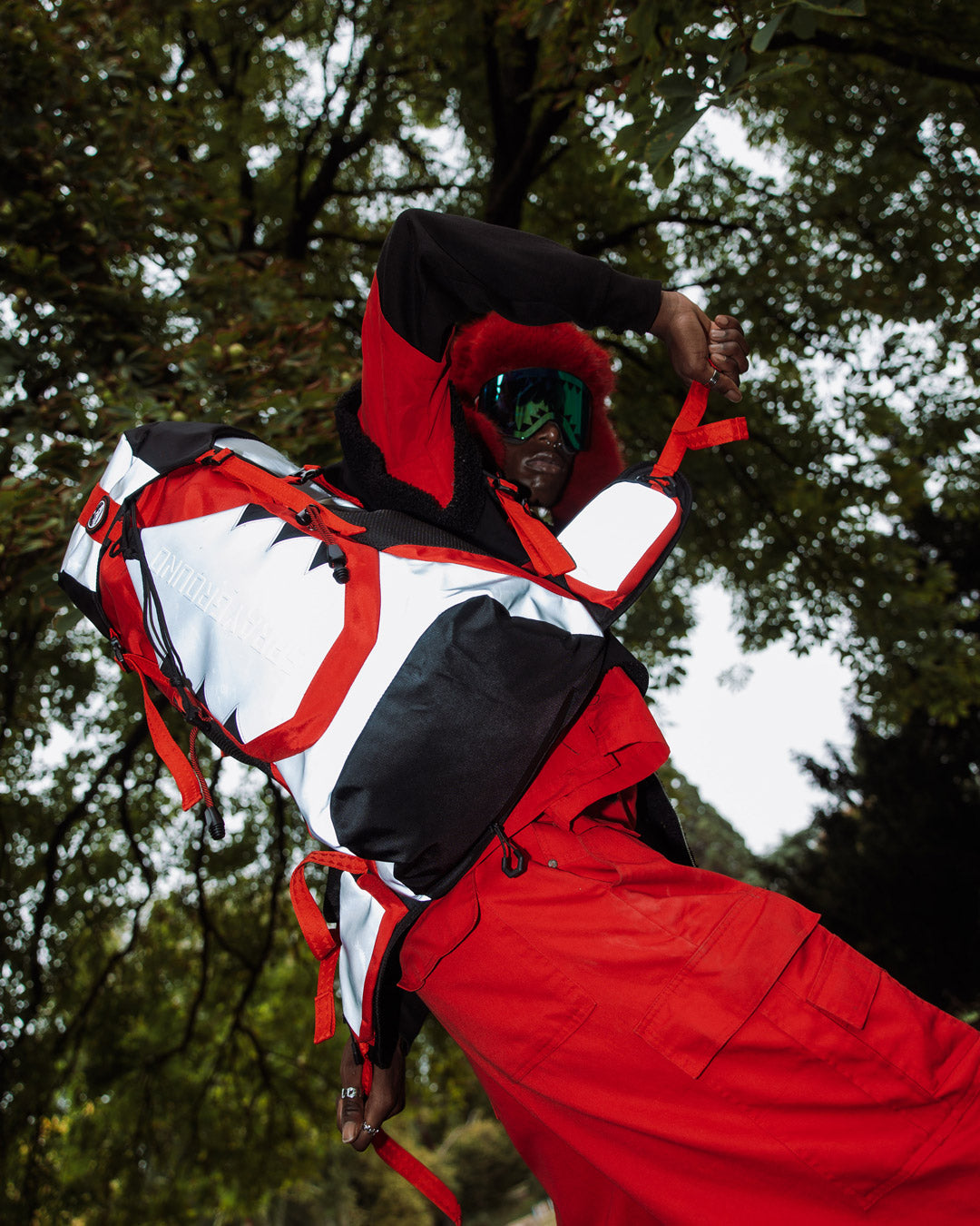 Detail of adjustable straps and emergency waterproof rain cover of the Arctic Trekking Backpack.