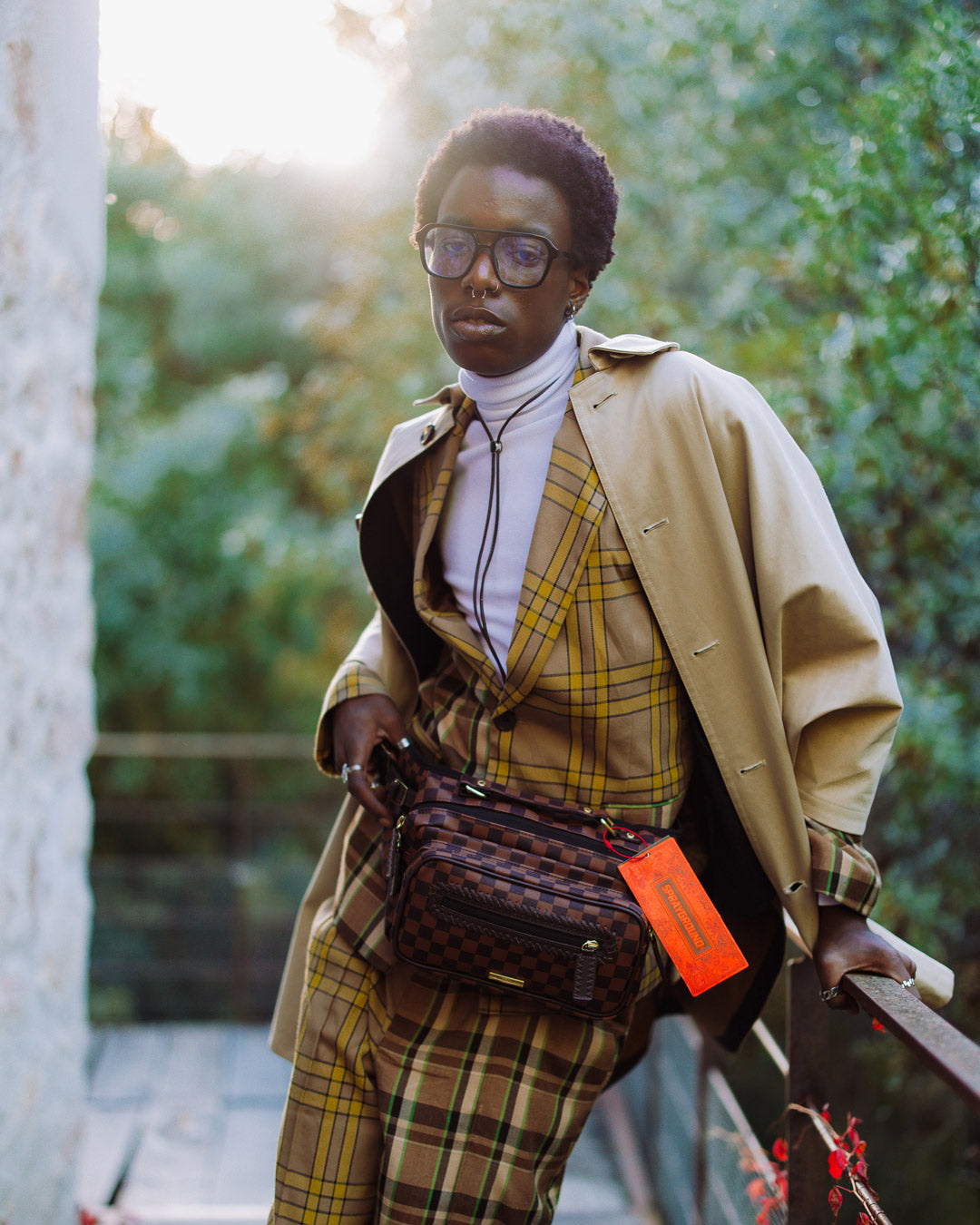 Model wearing the black crossbody bag while traveling.