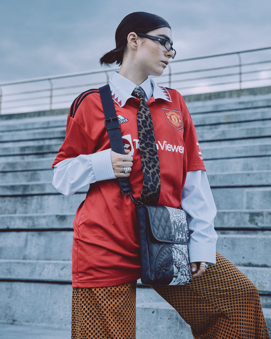Dark Wave messenger bag worn crossbody in an urban setting