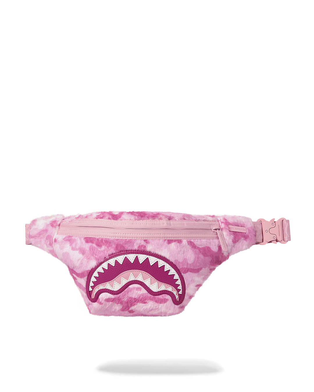 Pink Coach purse worn crossbody, showing strap adjustability and sleek profile.
