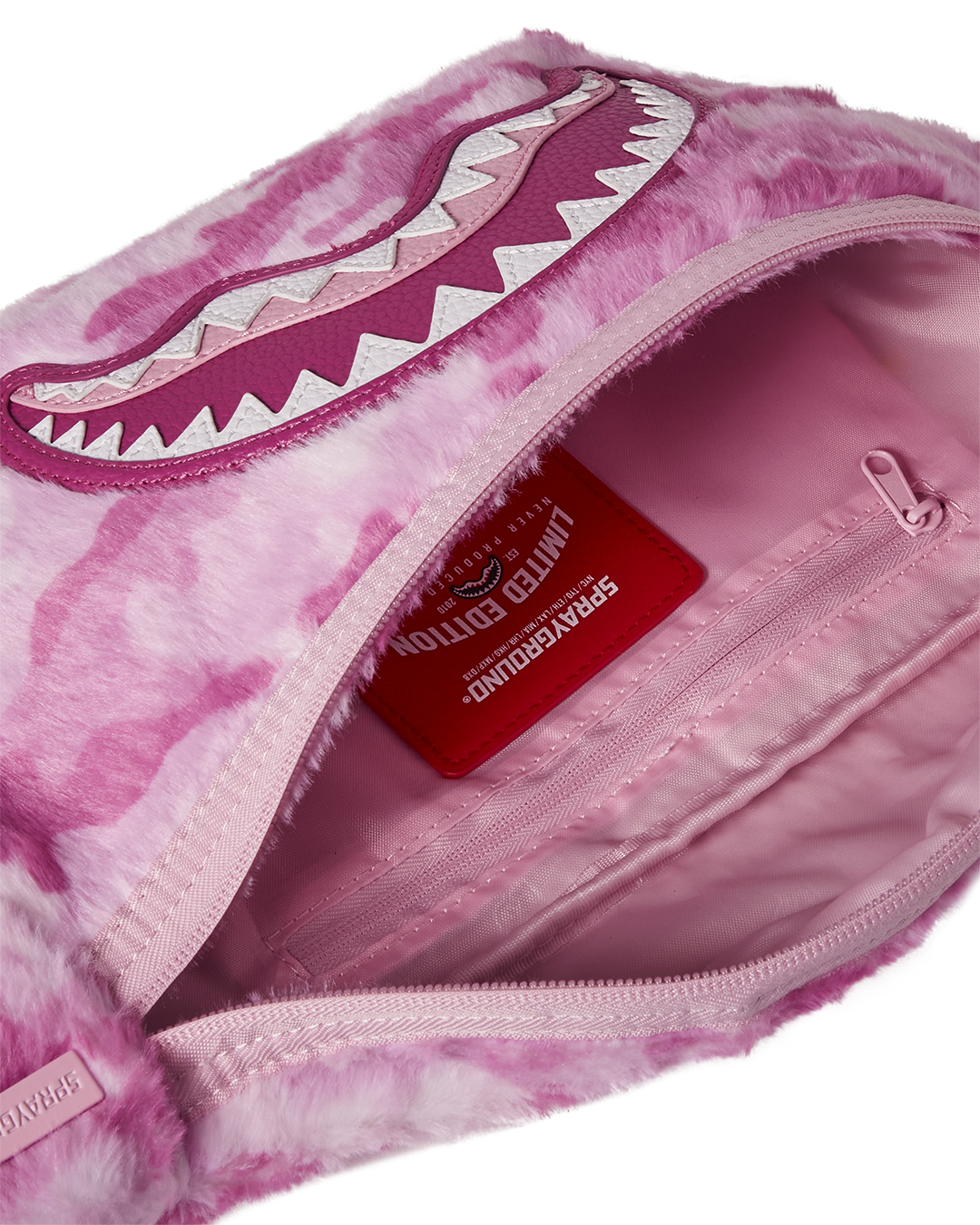 Pink Coach purse worn crossbody, showing strap adjustability and sleek profile.