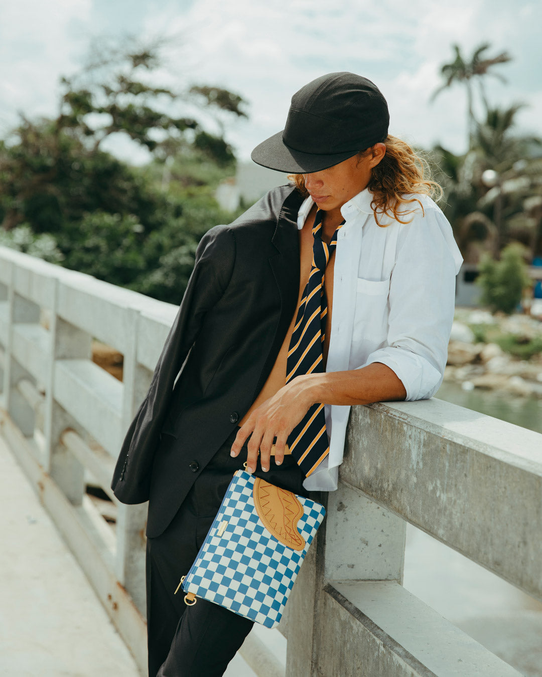 The clutch bag being carried as a crossbody bag, highlighting its adjustable strap