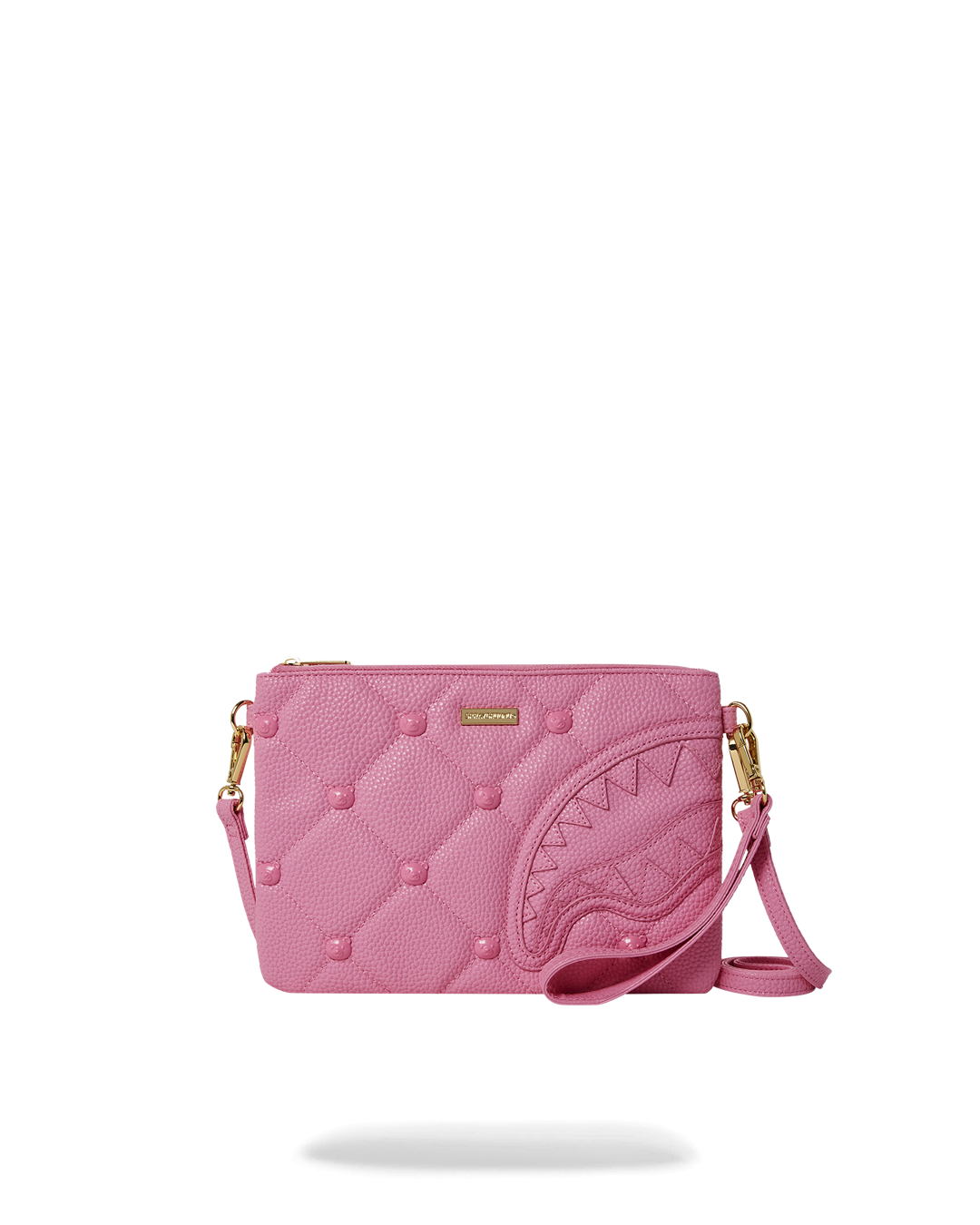 Pink Coach clutch bag held open, showing interior pocket and wristlet strap.