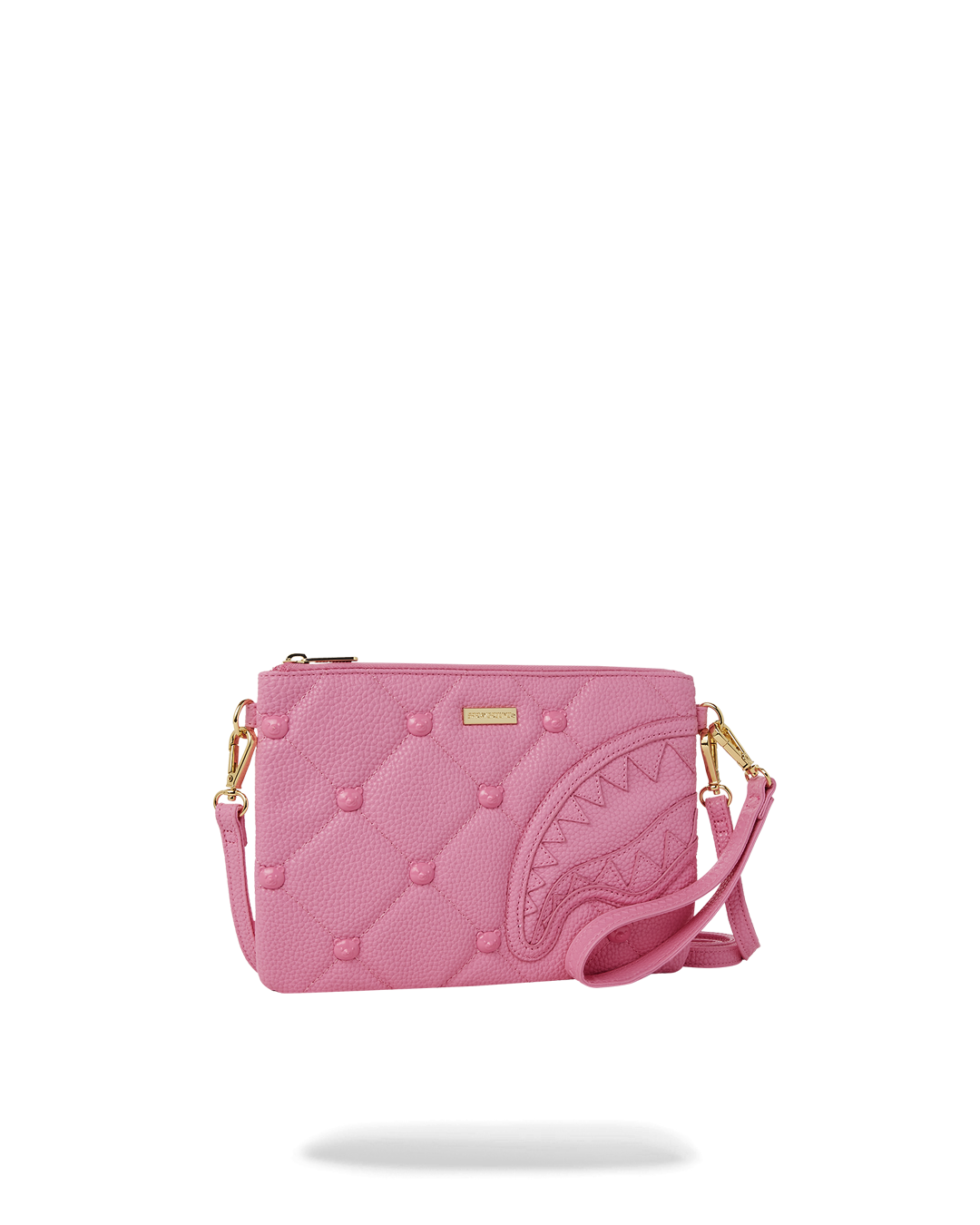 Convertible pink purse styled with gold jewelry for a night out.