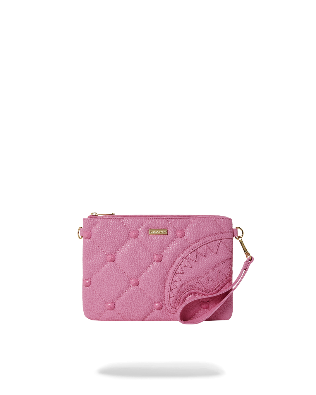Side view of quilted designer handbag with bear studs on a marble table.