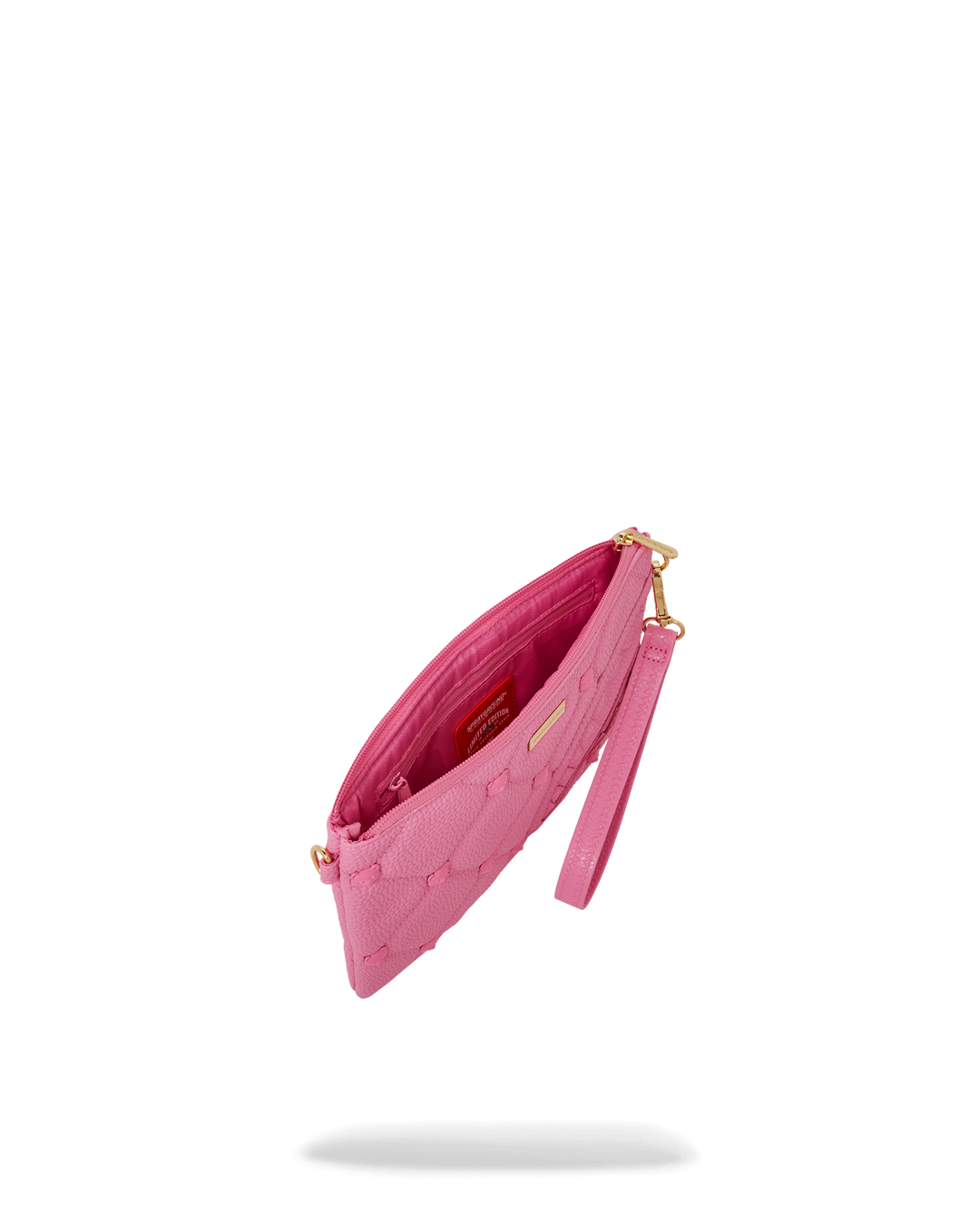 Convertible pink purse styled with gold jewelry for a night out.