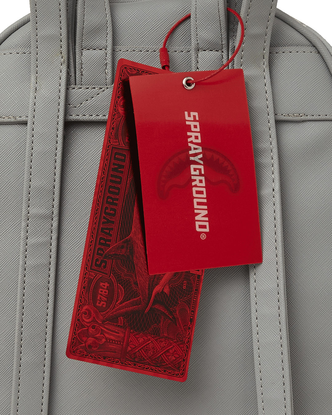 Close-up of the bags gold zippers and metal hardware