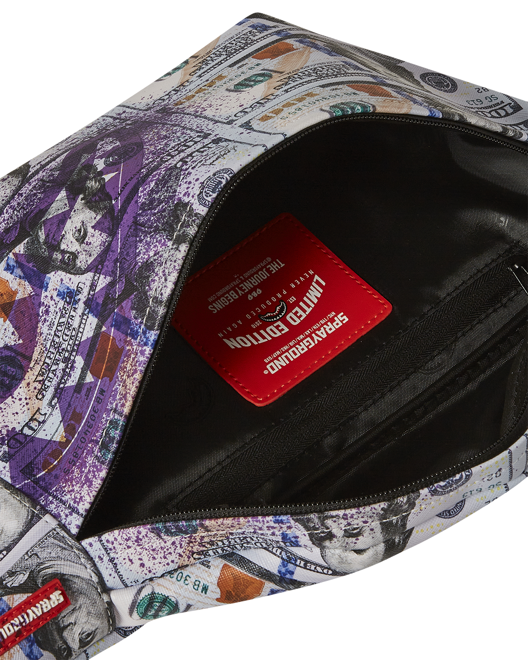 Close-up of the sleek black leather crossbody bag with red zipper detail
