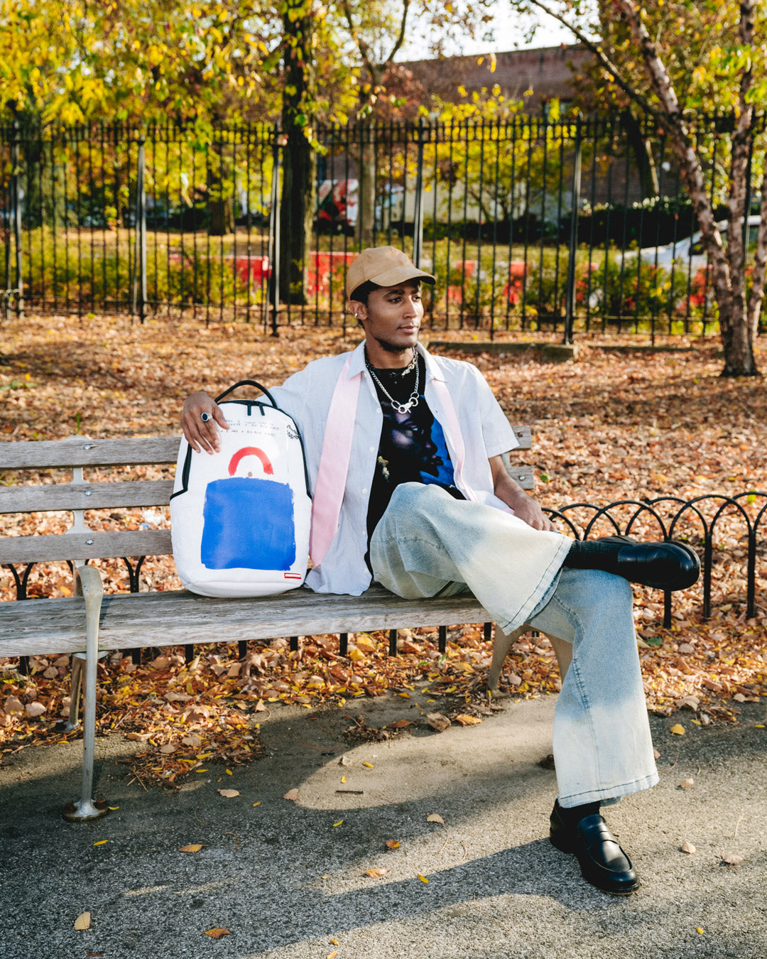 Front view of Keith Haring art backpack with bold design and gold zippers