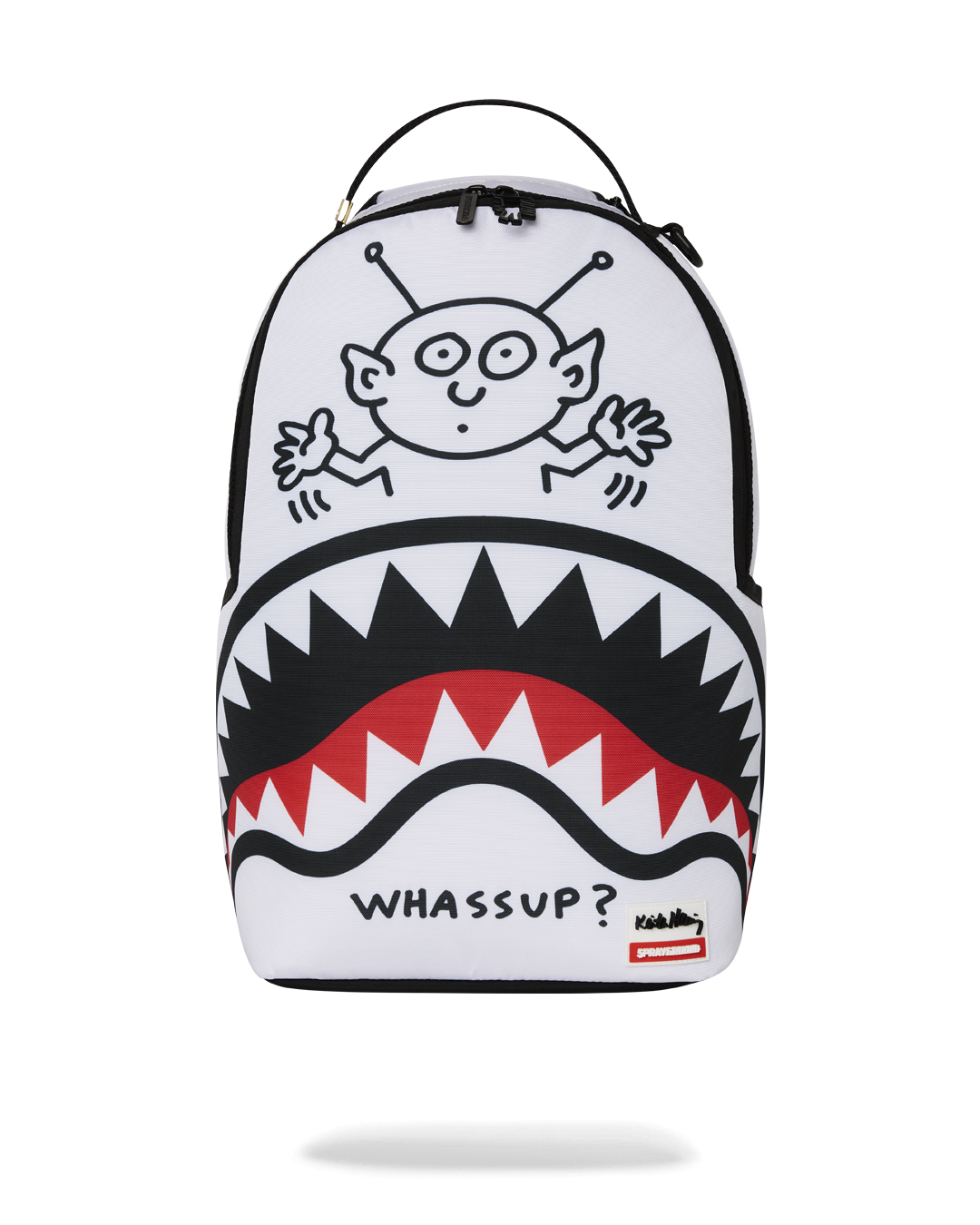Front-facing view of the pink Sprayground backpack with Keith Haring alien artwork