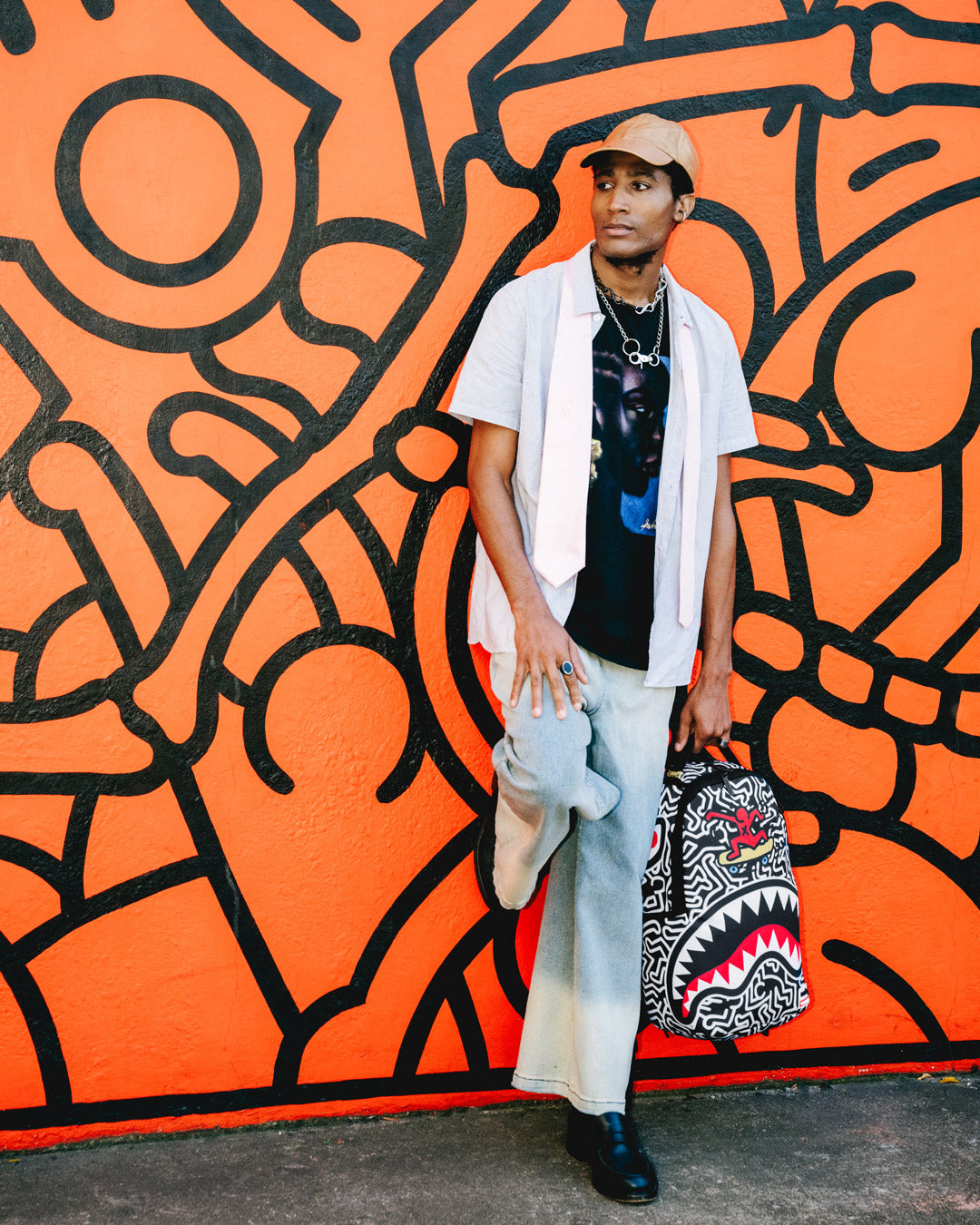 Front view of the Keith Haring shark design skater backpack showcasing the vibrant artwork.