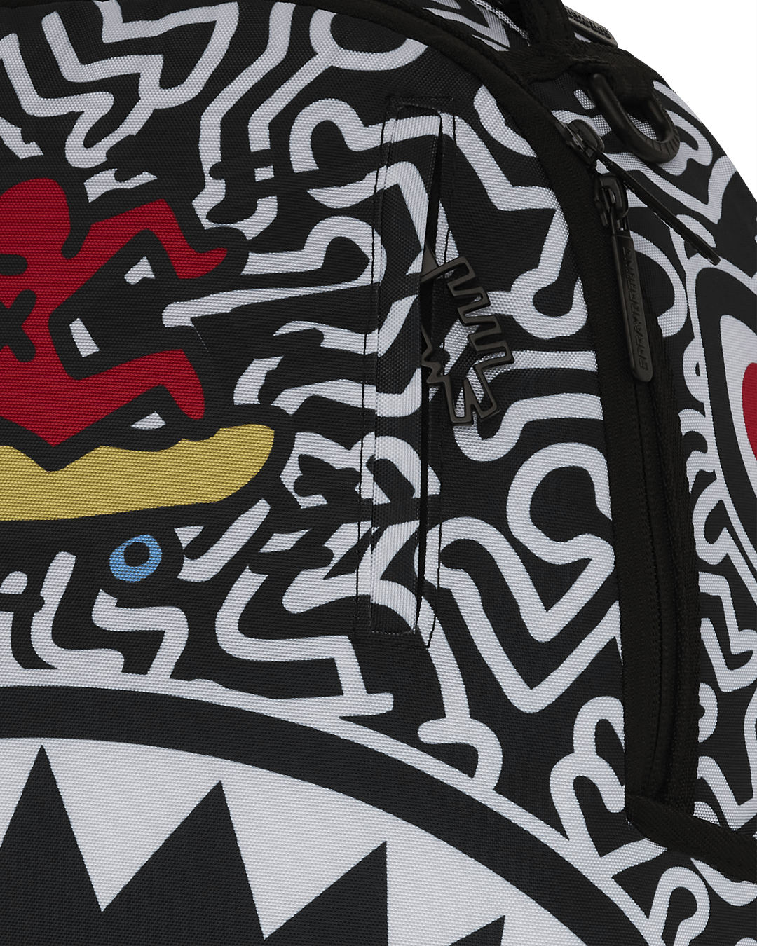 Front view of the Keith Haring shark design skater backpack showcasing the vibrant artwork.
