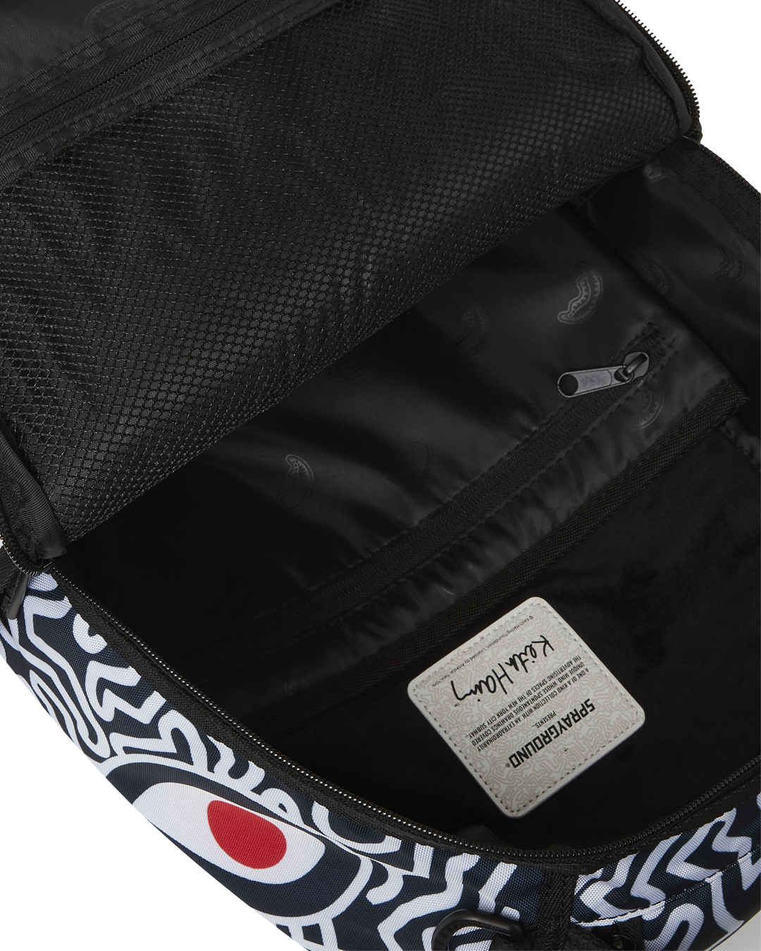 Close-up of the zipper and metal hardware on the Keith Haring backpack.