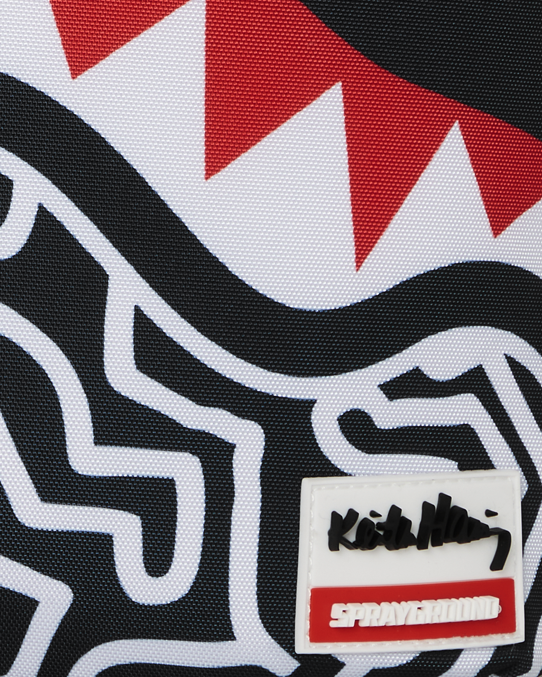 Front view of the Keith Haring shark design skater backpack showcasing the vibrant artwork.