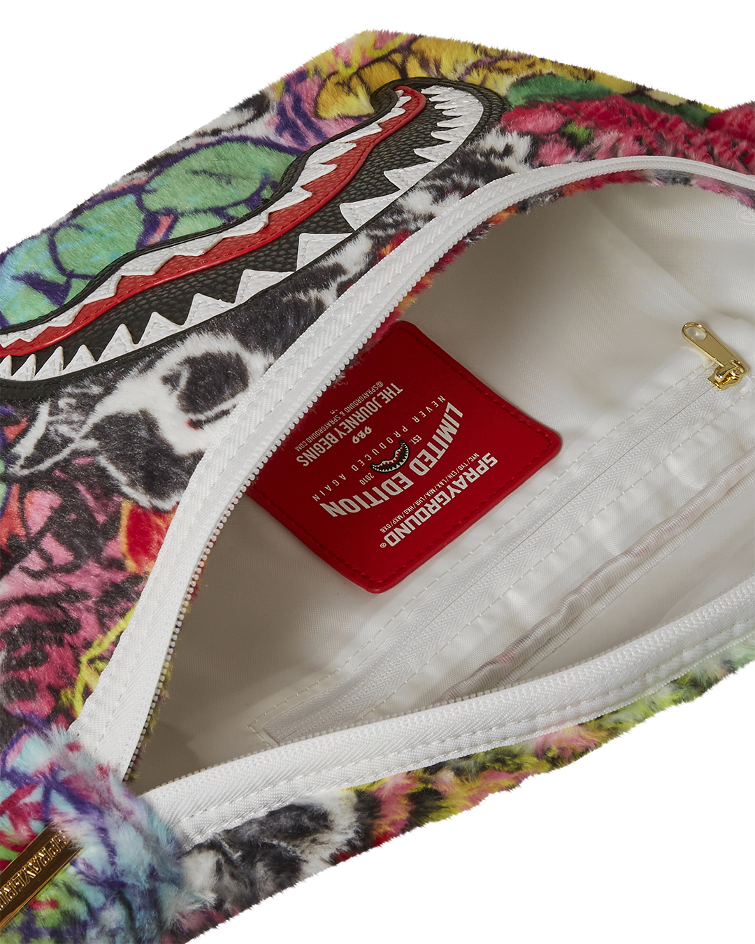 Stylish graffiti crossbody bag displayed against an urban backdrop.