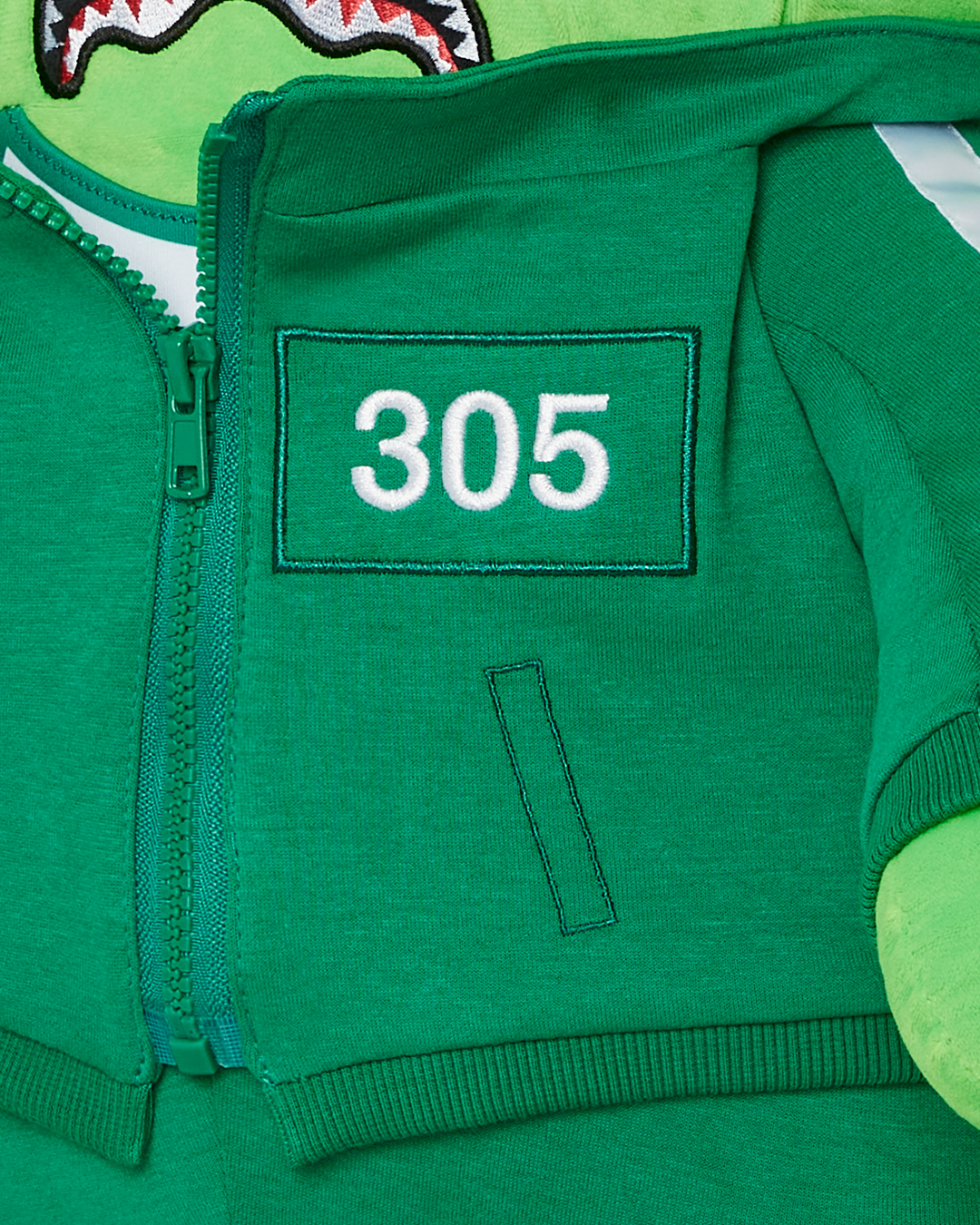 Close-up of the zippered pockets on the Sprayground money bear backpack.