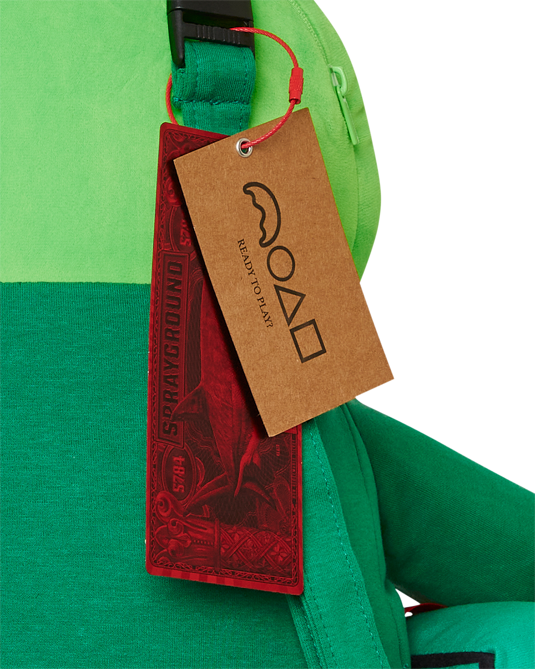 Close-up of the zippered pockets on the Sprayground money bear backpack.