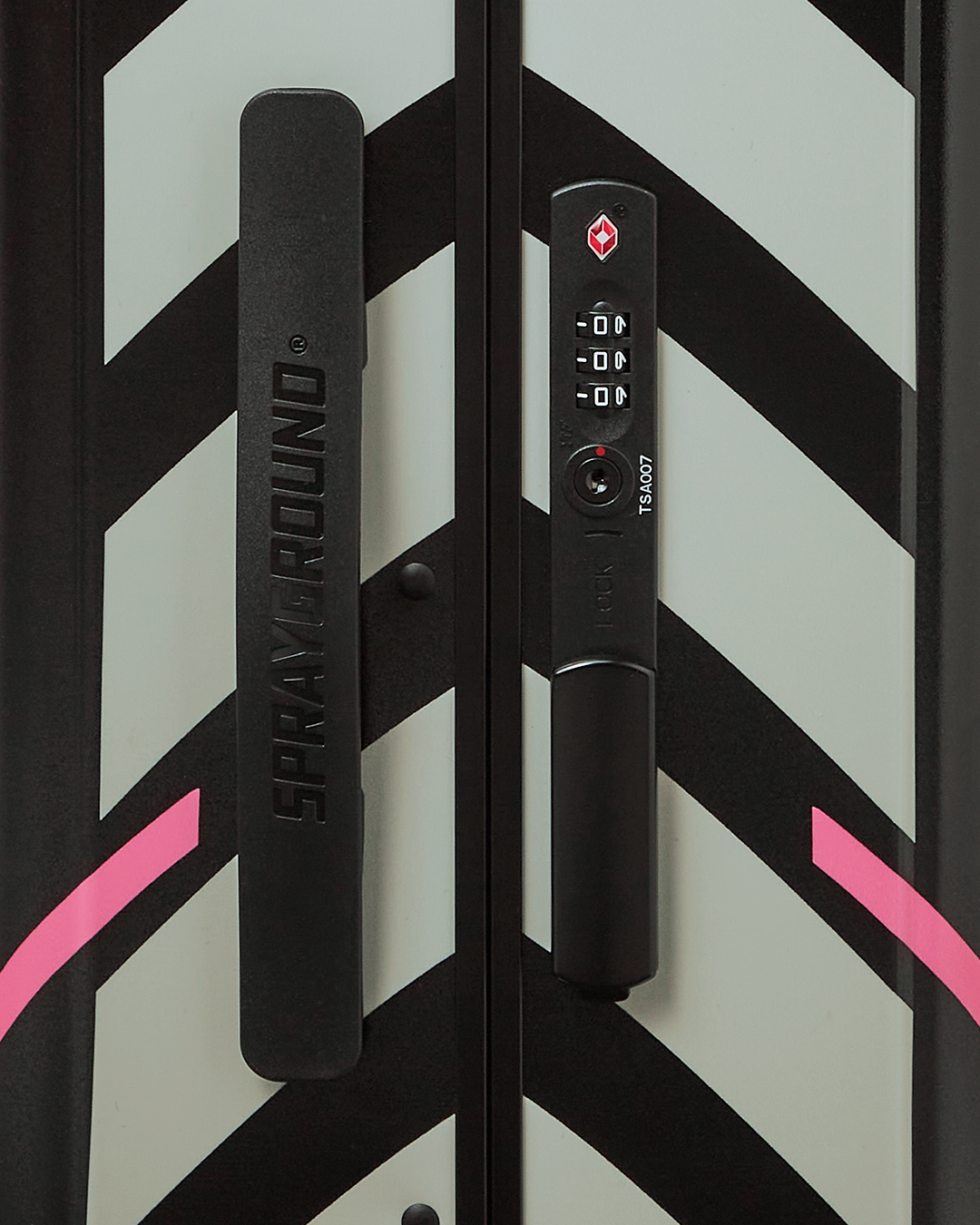 Close-up of TSA lock and telescoping handle on durable hardshell suitcase