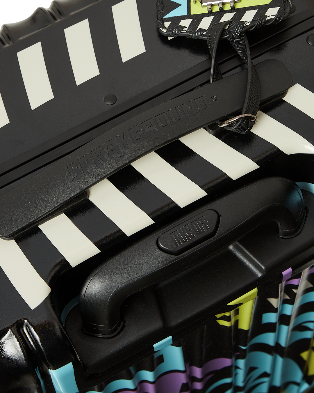 Close-up of TSA lock and telescoping handle on durable hardshell suitcase