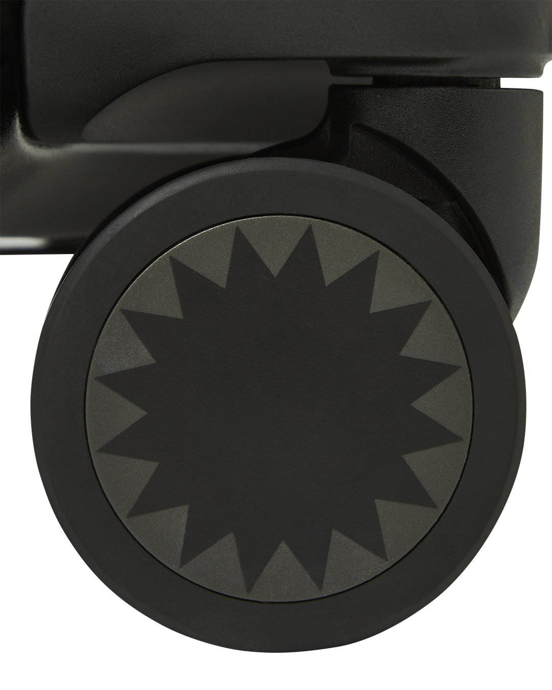 Close-up of JetBlack luggage with gold hardware and double spinner wheels.