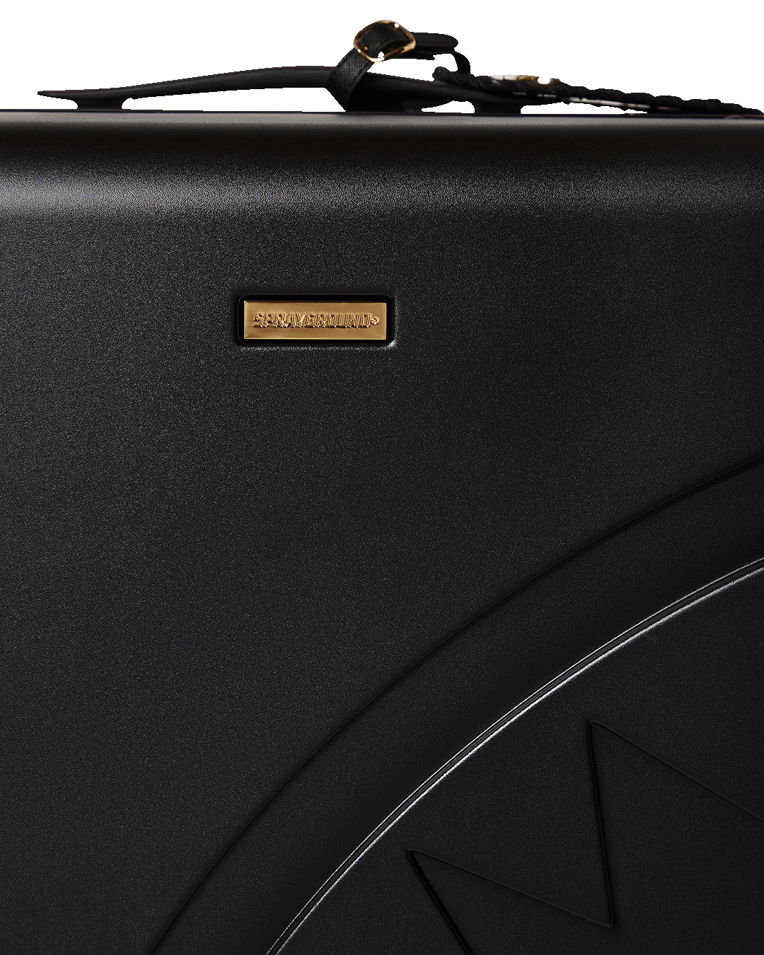 Close-up of JetBlack luggage with gold hardware and double spinner wheels.