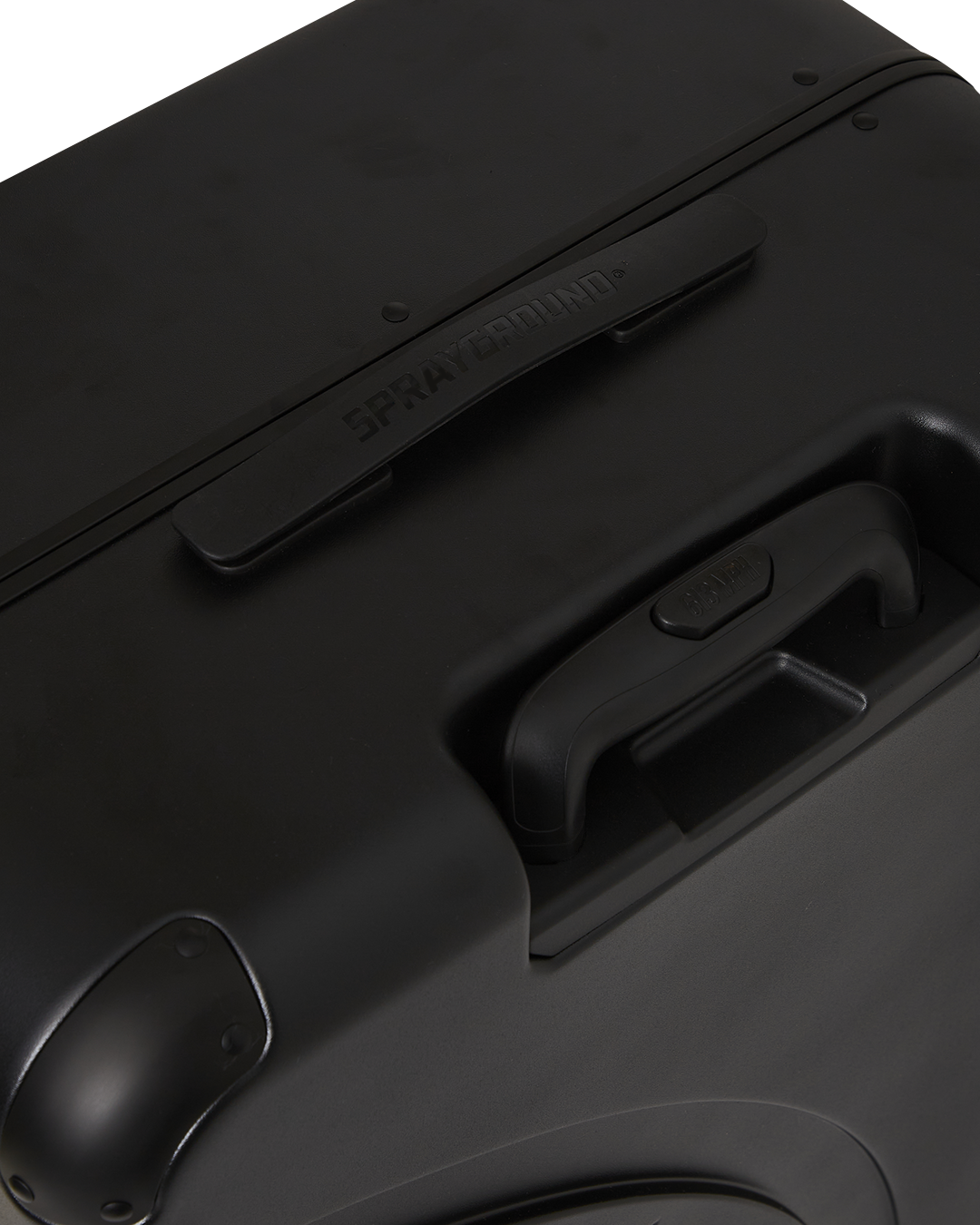 Side profile of full-size JetBlack luggage on a city street.