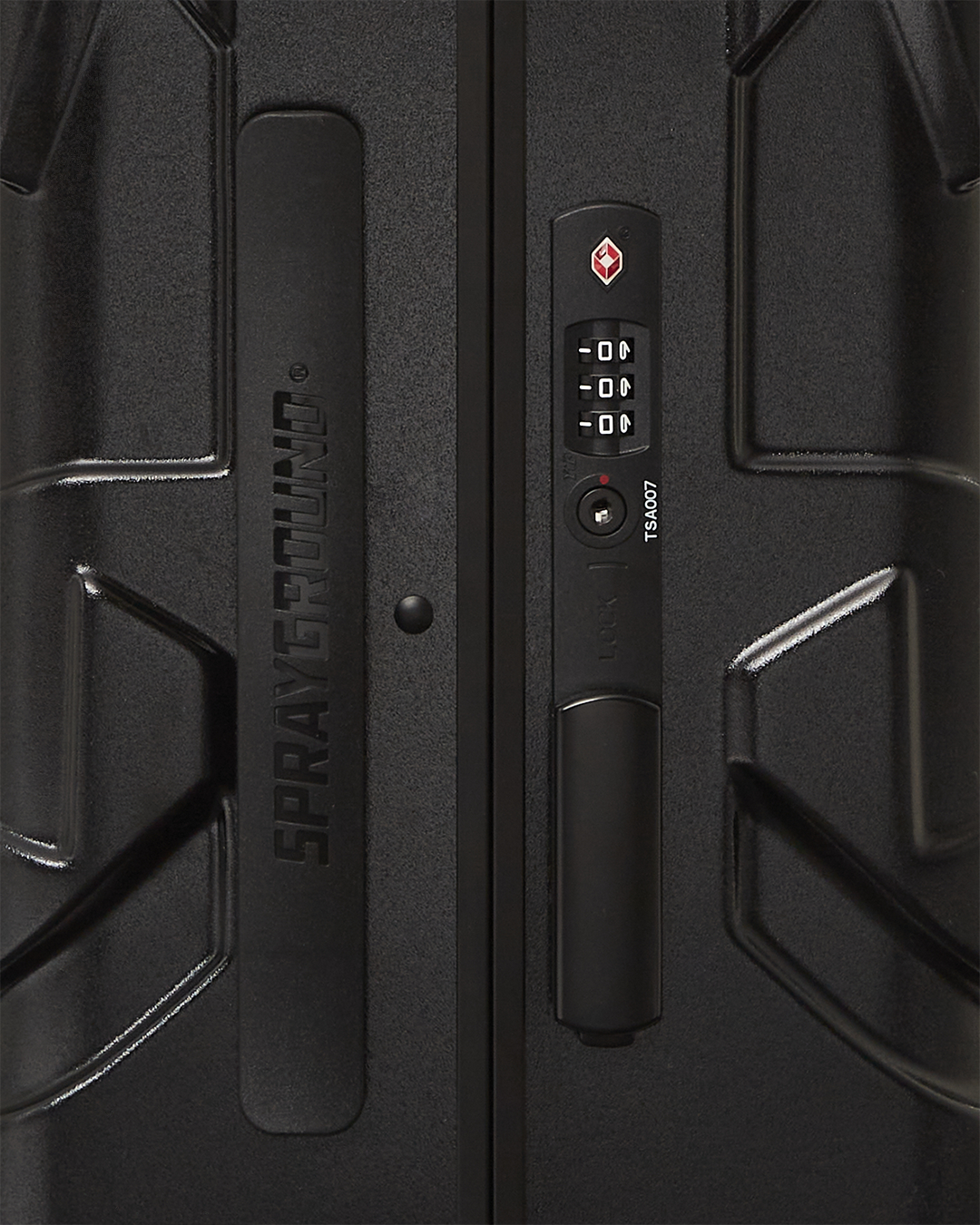 Close-up of Nightsharks polycarbonate luggage showing TSA-approved locks and sleek shark sculpture.