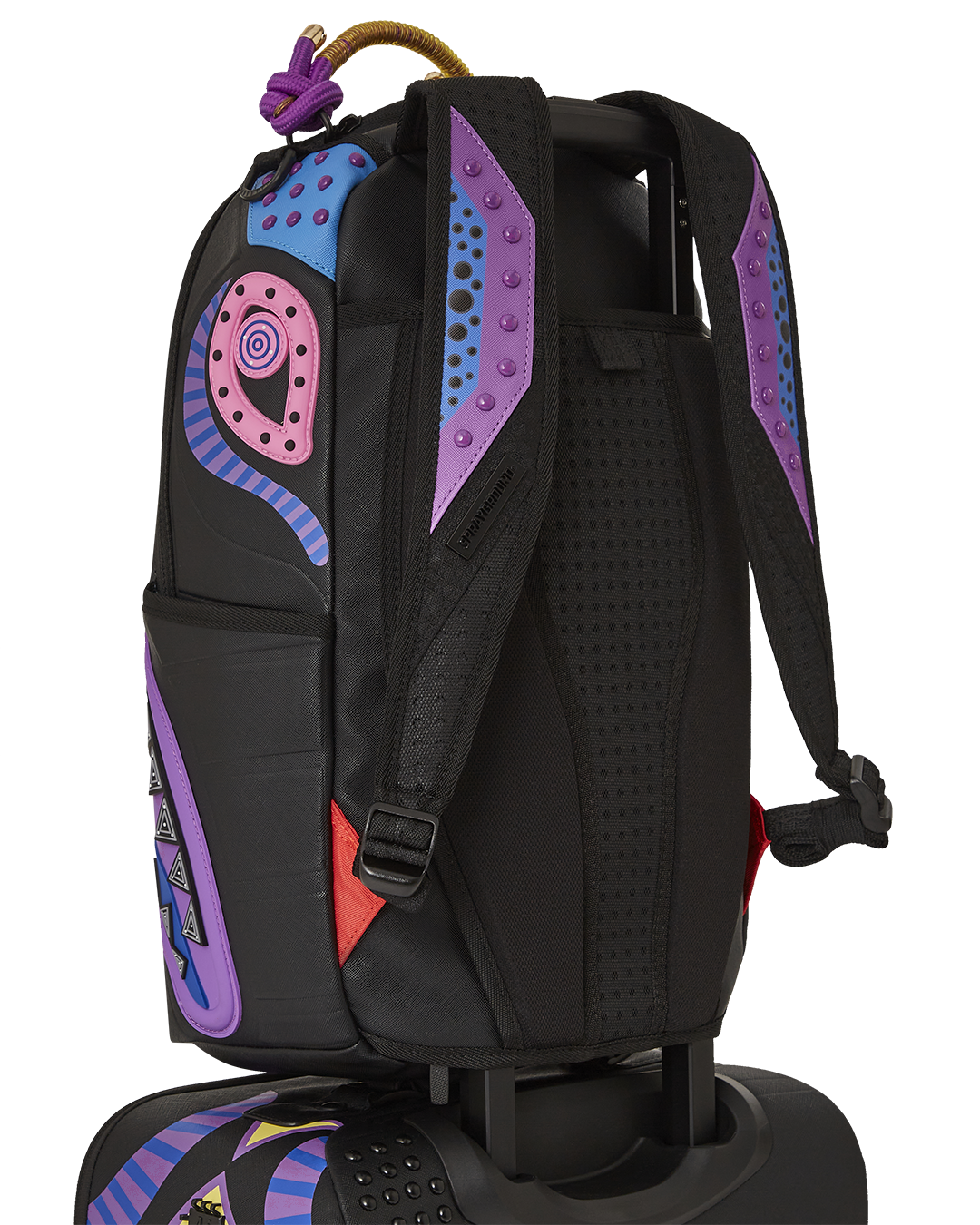 Side profile of hard shell luggage with spinner wheels, placed near a travel backpack
