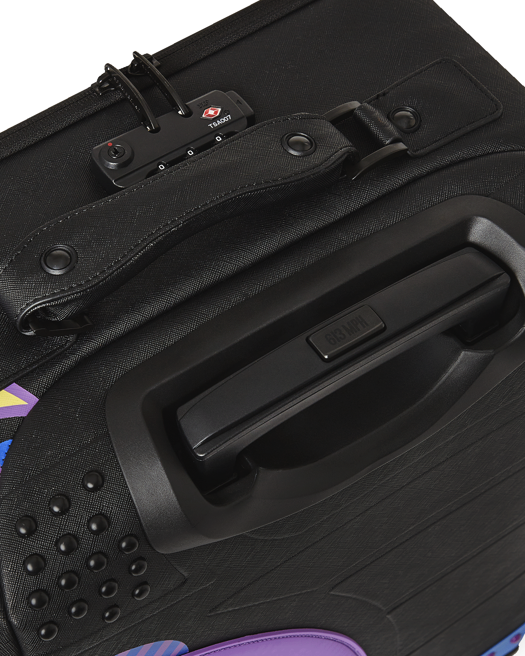 Side profile of hard shell luggage with spinner wheels, placed near a travel backpack