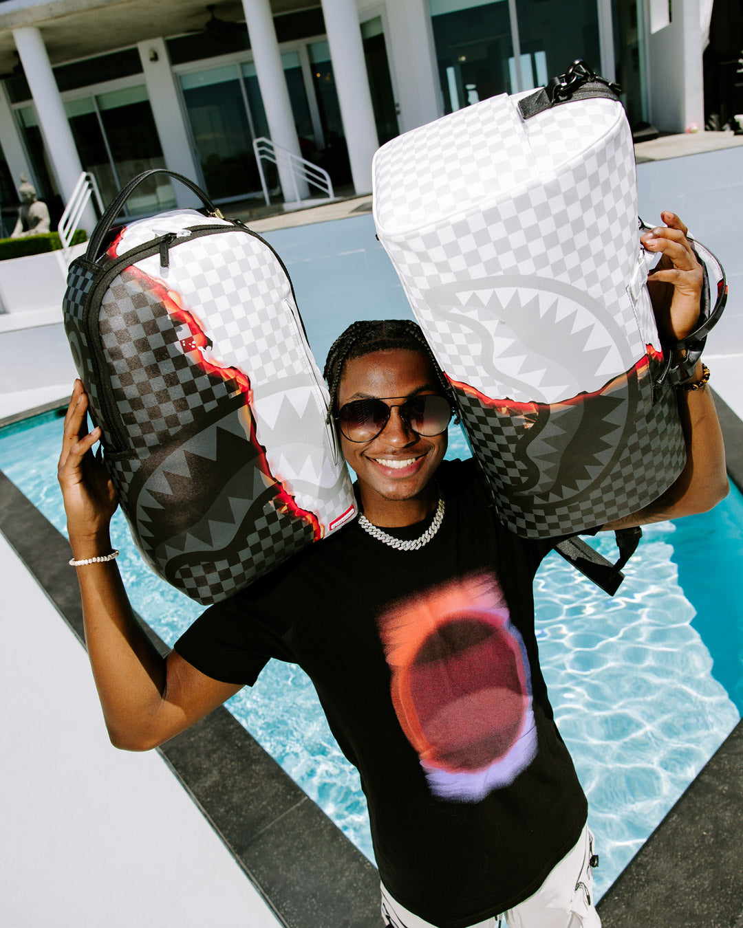 Front view of large duffle showing zippered sneaker pocket and gold accents