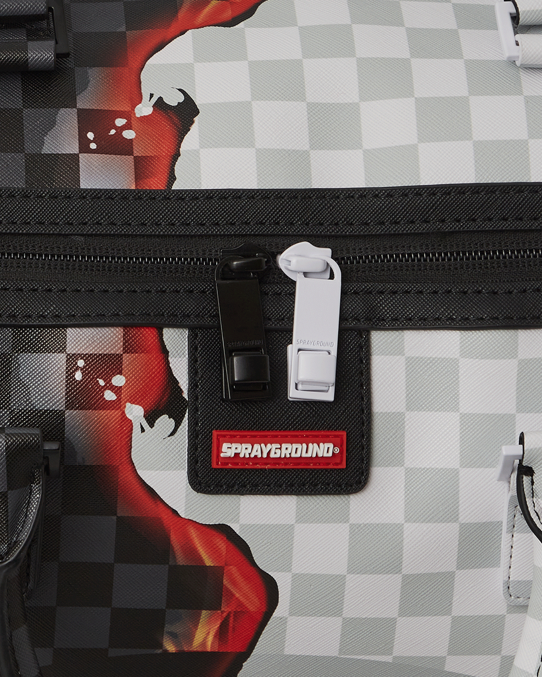Close-up of metal hardware and faux leather fabric on travel duffle bag