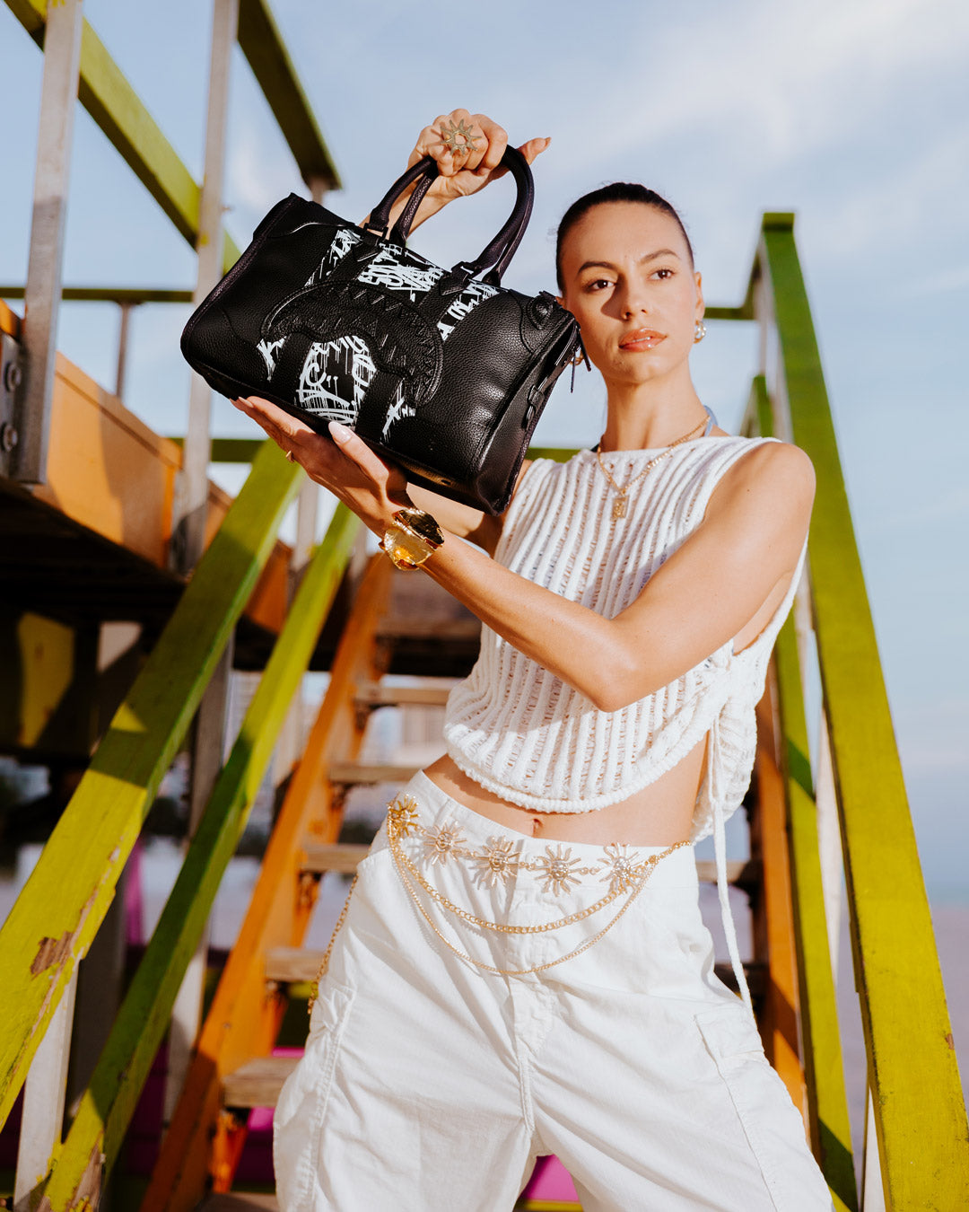 Mini duffle bag styled with laptop and water bottle for work or gym