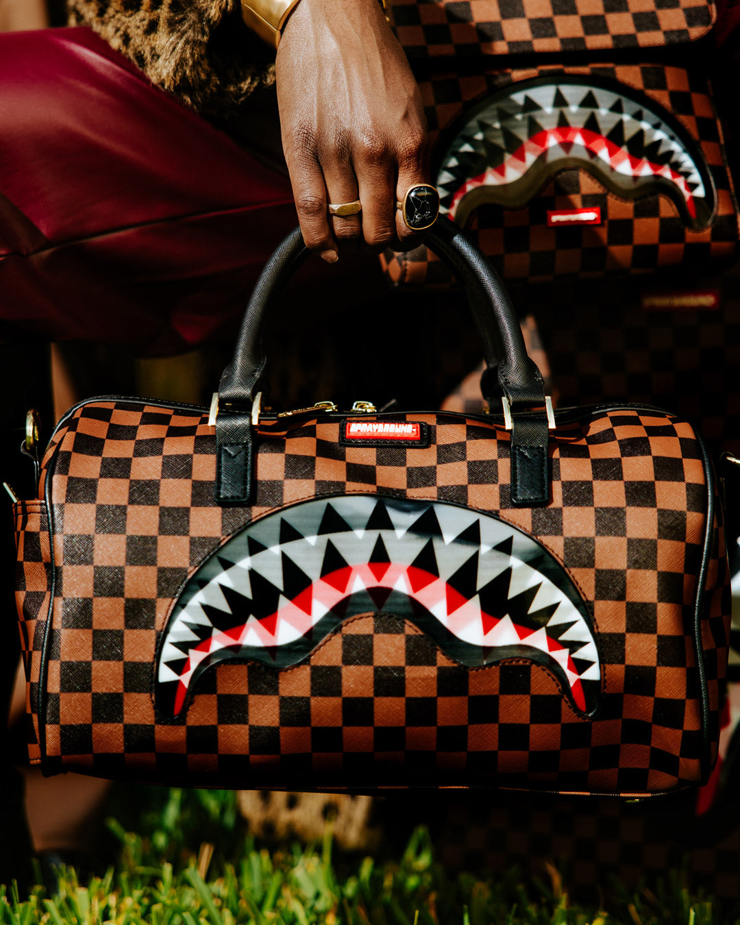 Sharkmouth Mini Duffle Bag worn crossbody with adjustable strap