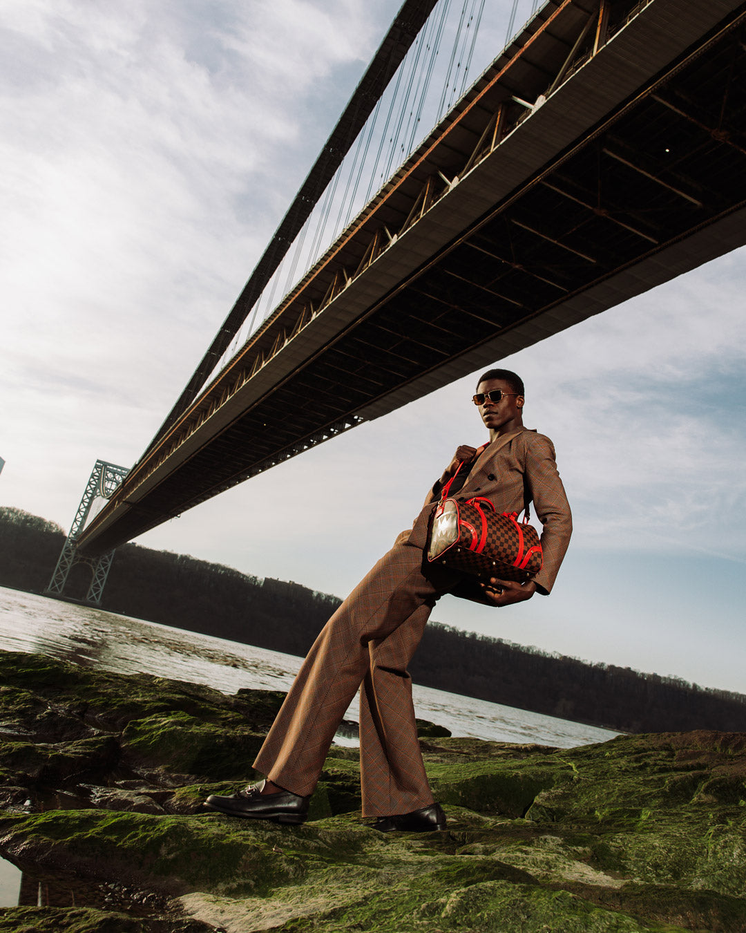 Mini duffle bag worn crossbody, showing adjustable strap