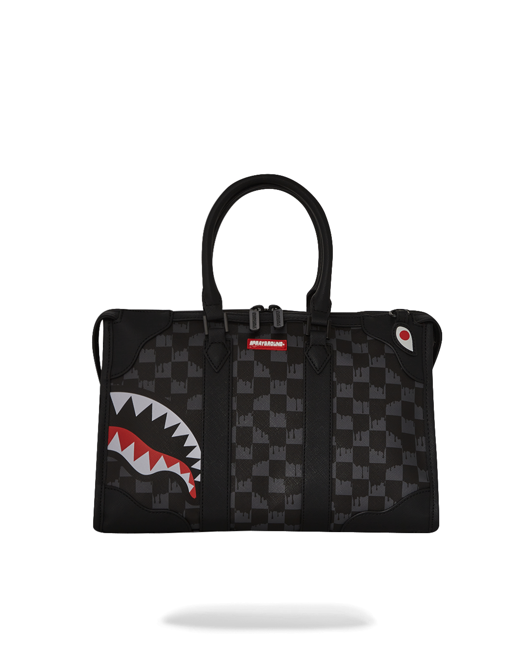 Pyramid-shaped faux leather duffle bag worn crossbody in city setting