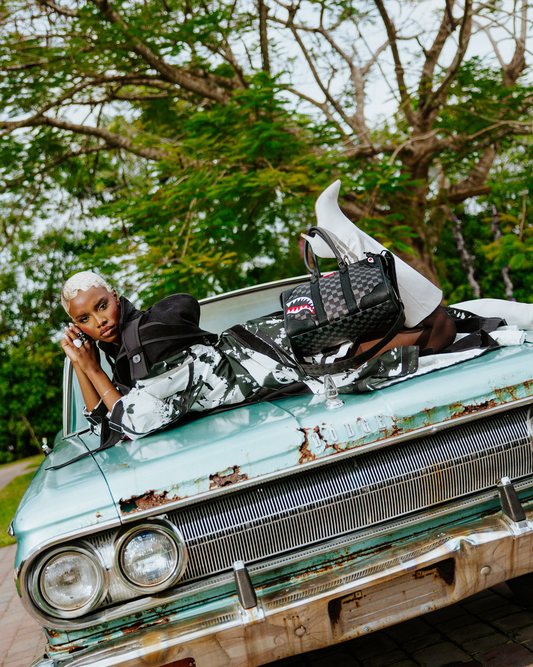 Stylist holding the pyramid bag alongside a matching tote