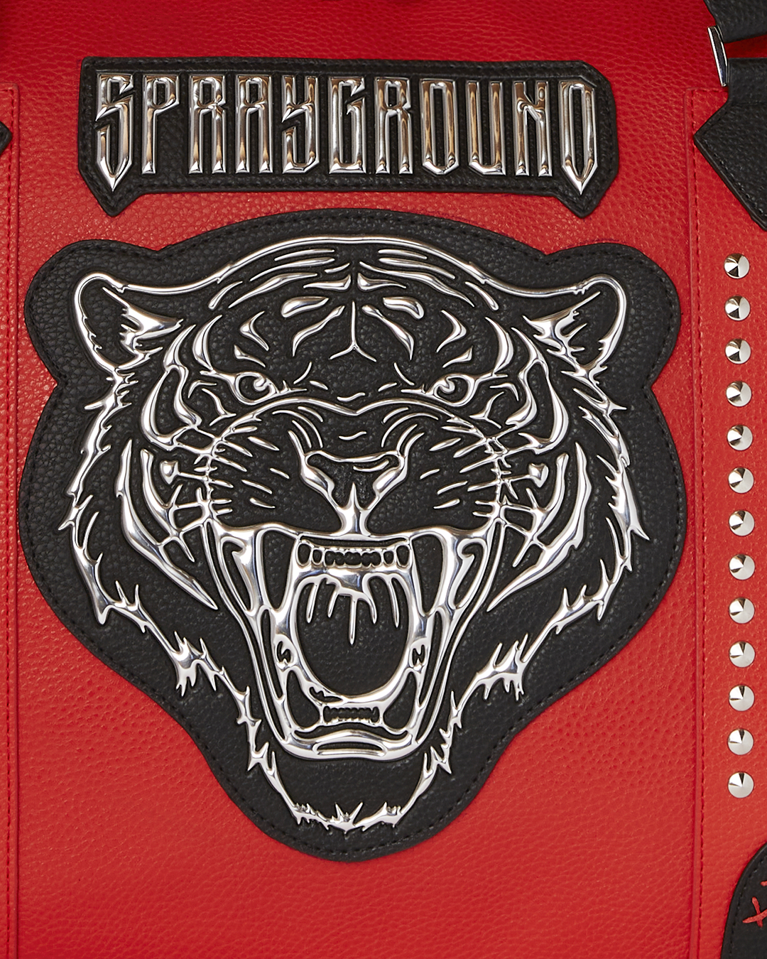 Close-up of the studding and metallic artwork on the duffle.