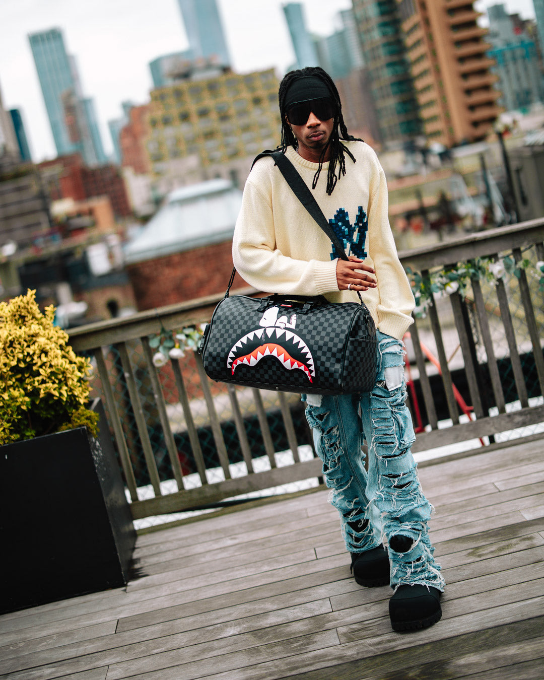 Snoopy faux leather duffle bag showcasing its spacious interior and zippered pockets.