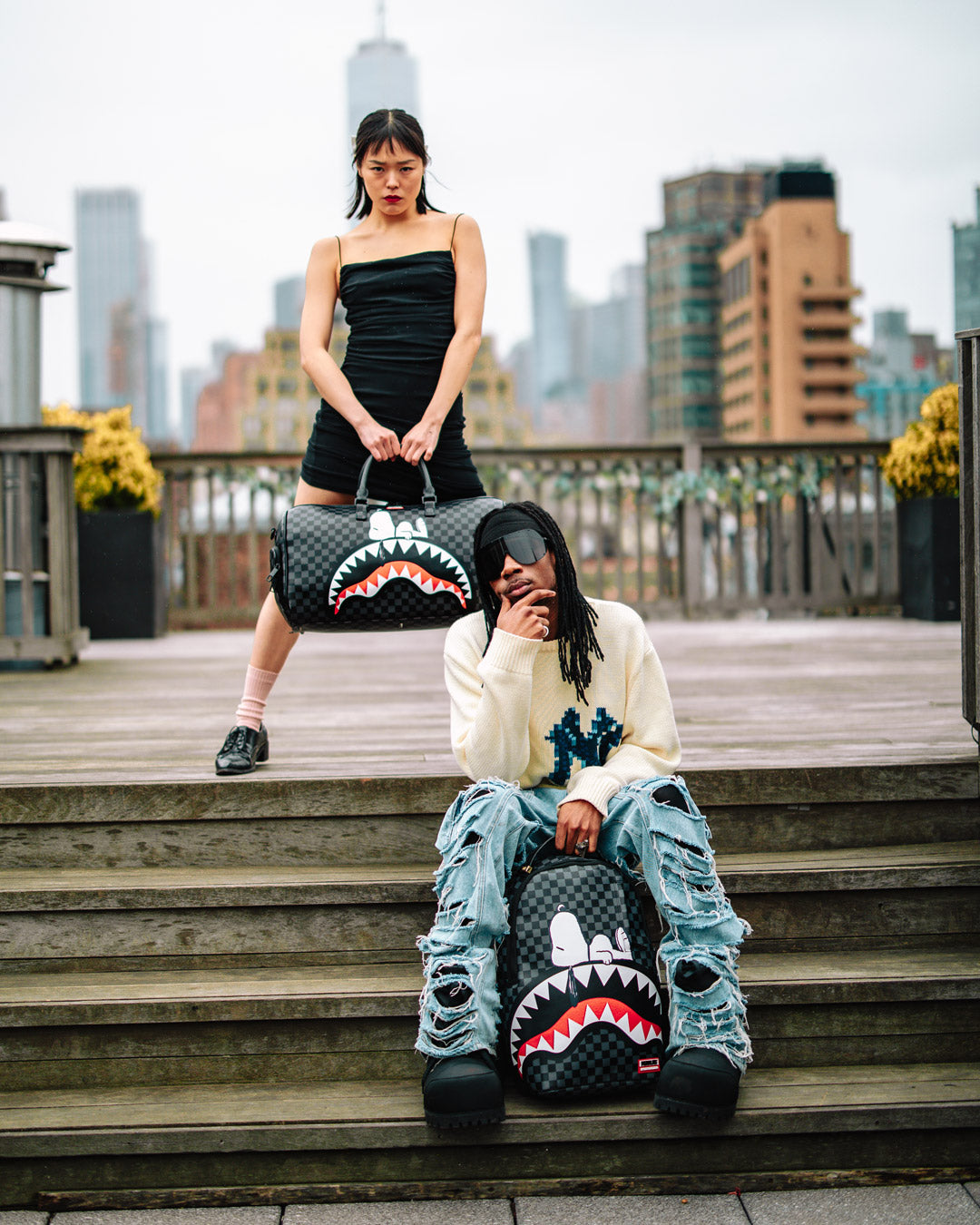 Snoopy duffle bag being carried with adjustable straps, perfect for travel.