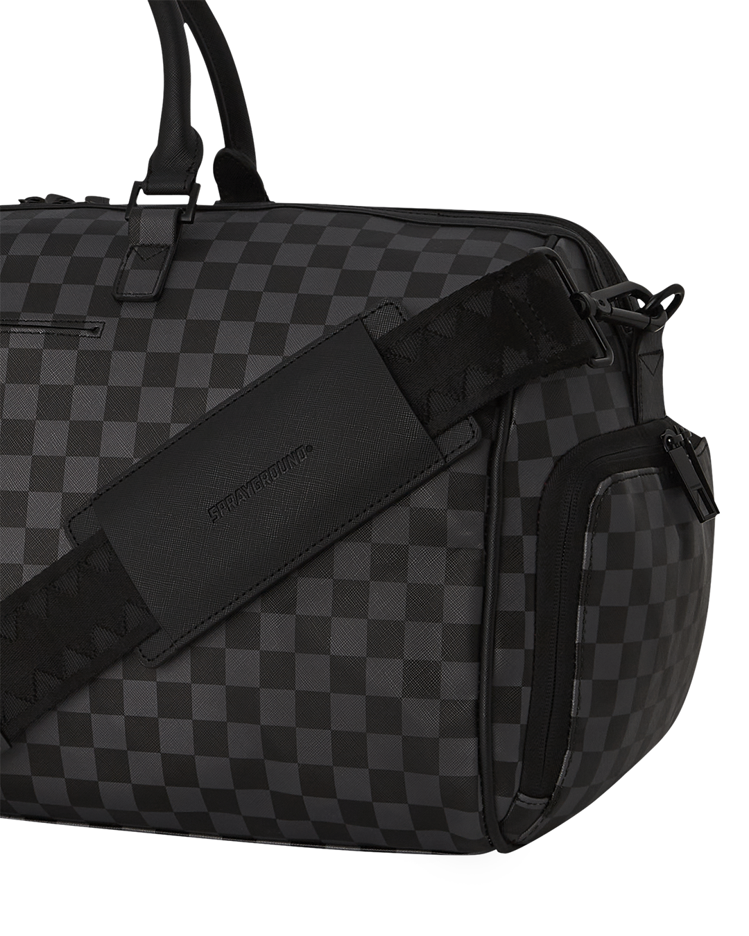 Close-up of the duffle bags gold zippers and water-resistant fabric.