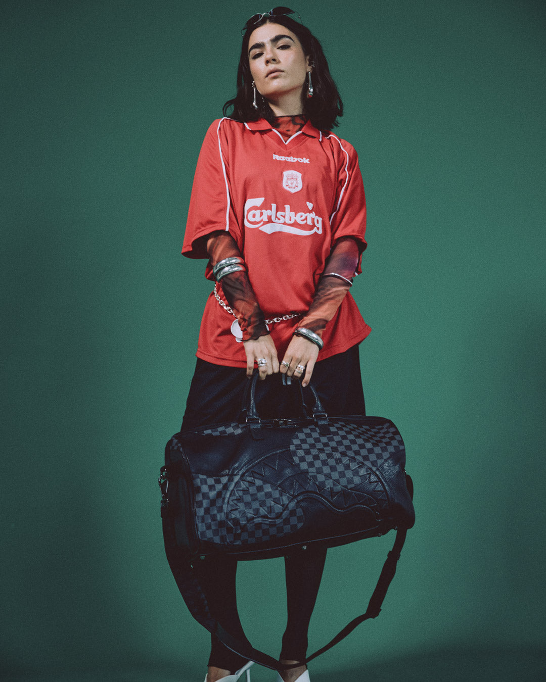 Side profile showing sneaker pocket on mens designer duffle bag