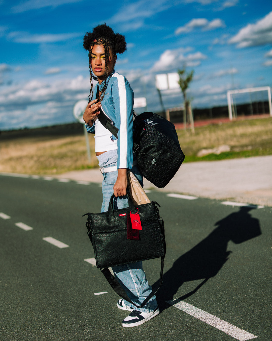 Faux leather duffle bag with a sleek design and adjustable straps, ideal for travel.