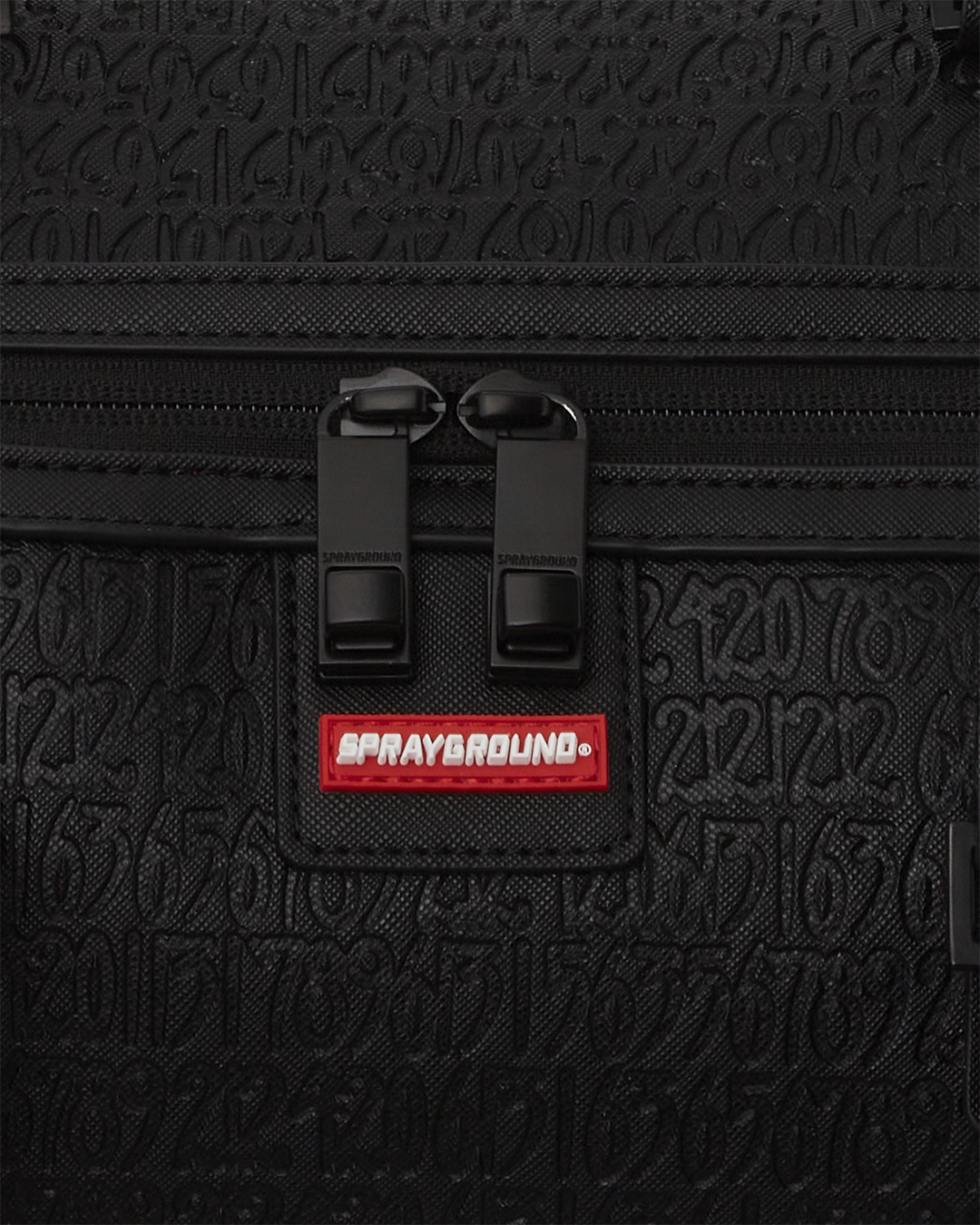 Close-up of the bags gold zippers and metal hardware, showcasing its premium quality.
