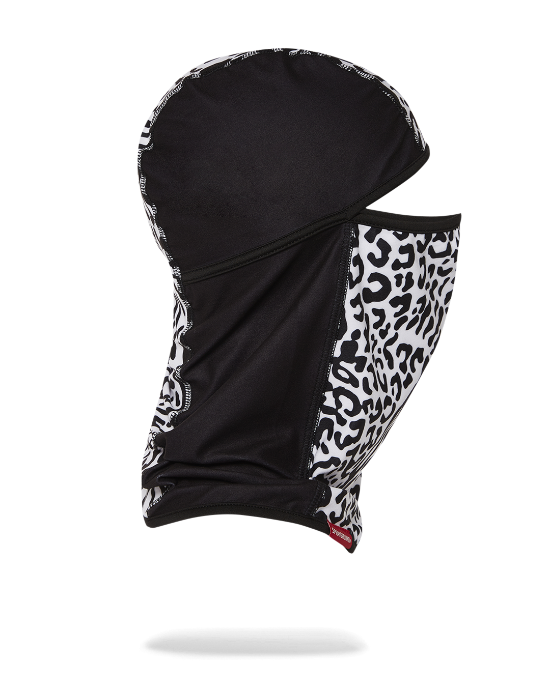 Person wearing ski mask in snowy outdoor setting.