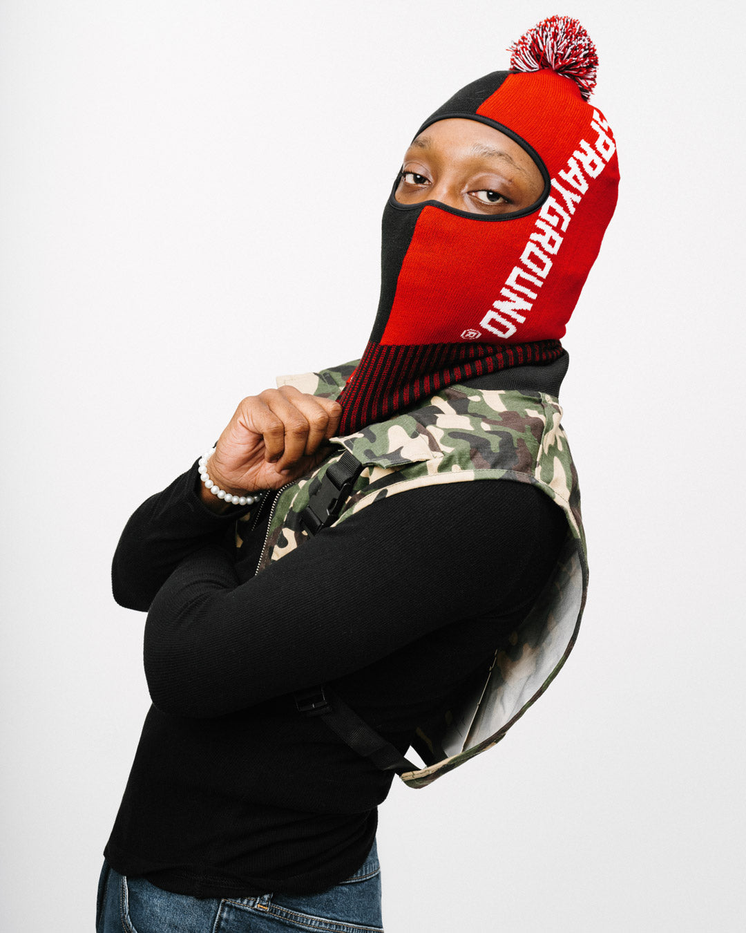 Front view of the knitted pom ski mask, showcasing its stylish design.