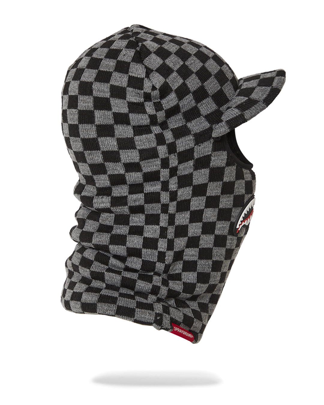 Close-up of ski helmet with visor and thick knitted construction for cold weather.