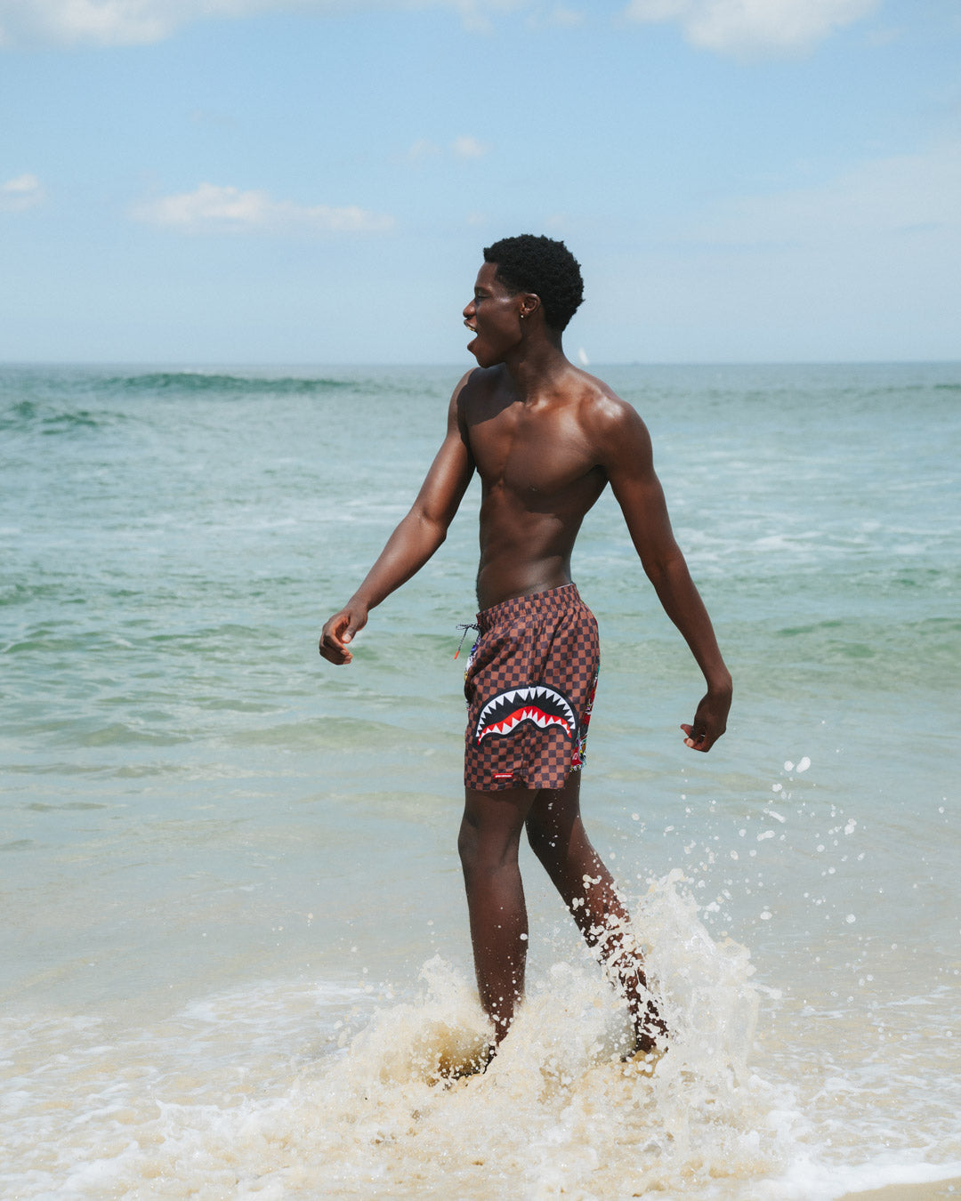 Man swimming in Fair Harbor swim trunks, showcasing flexibility