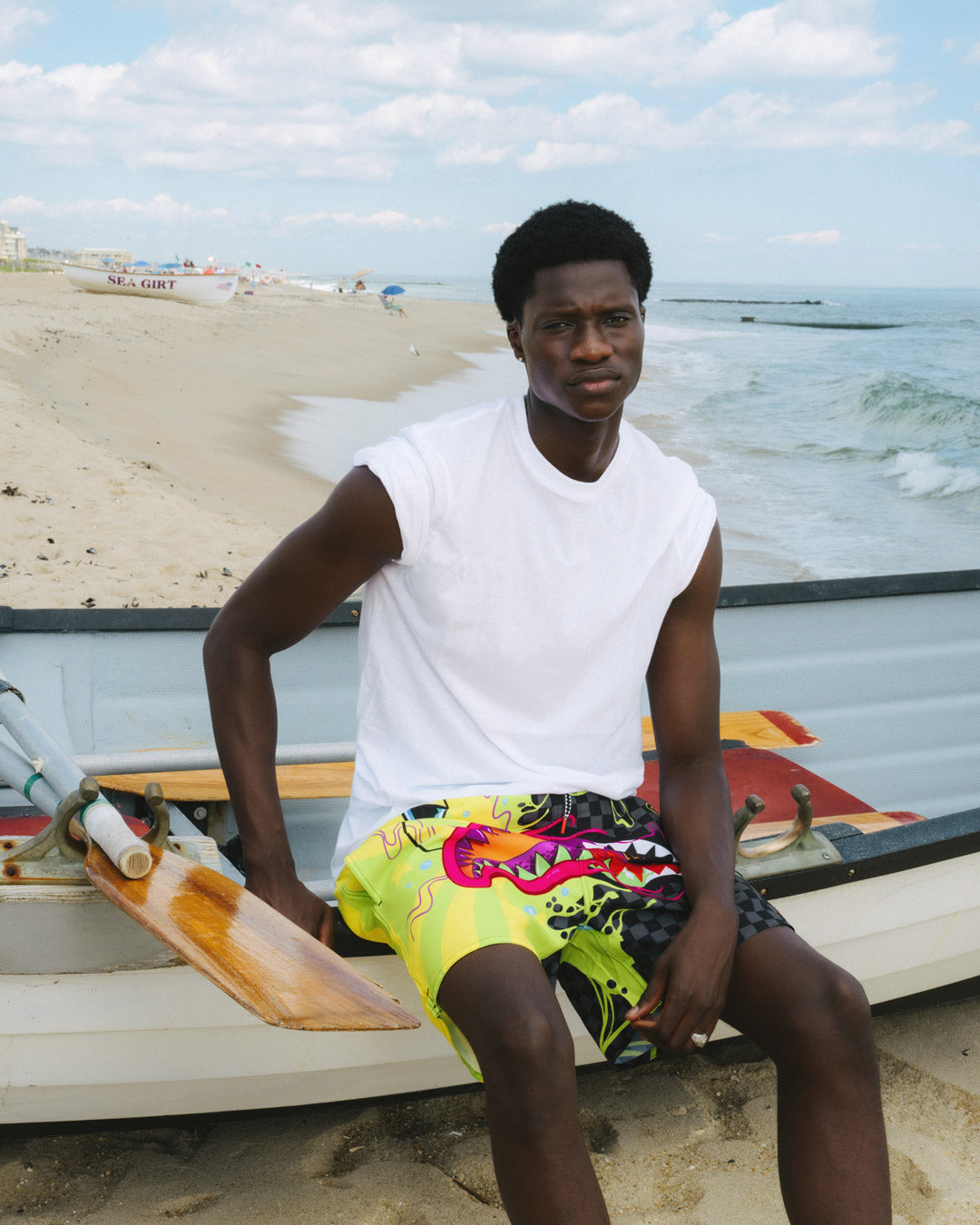 Slime Dime mens swim shorts in stretch fabric, shown on a beach